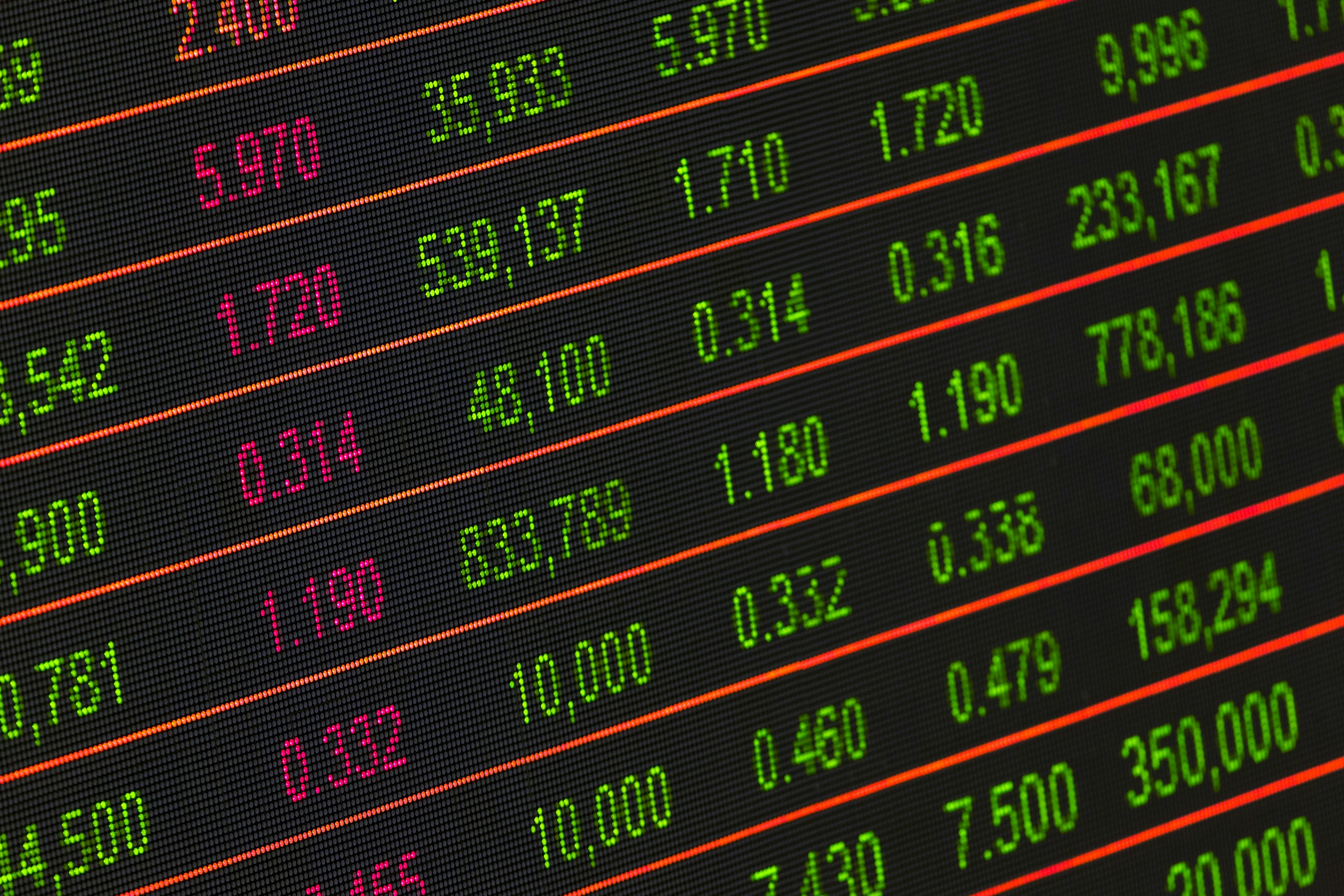 Close-up of a digital stock market data display showing financial numbers and market trends