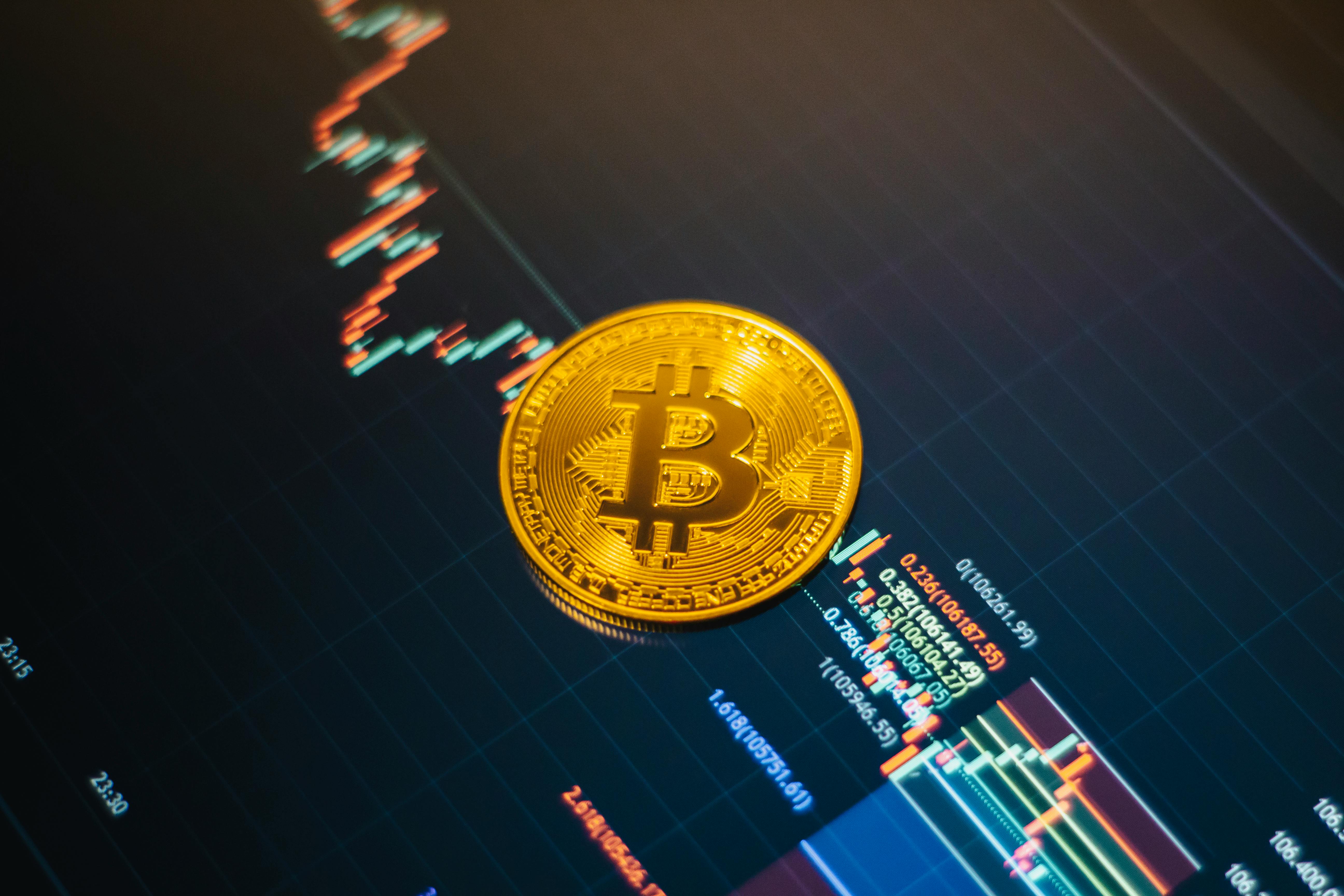 Golden Bitcoin coin on a rising digital financial market chart