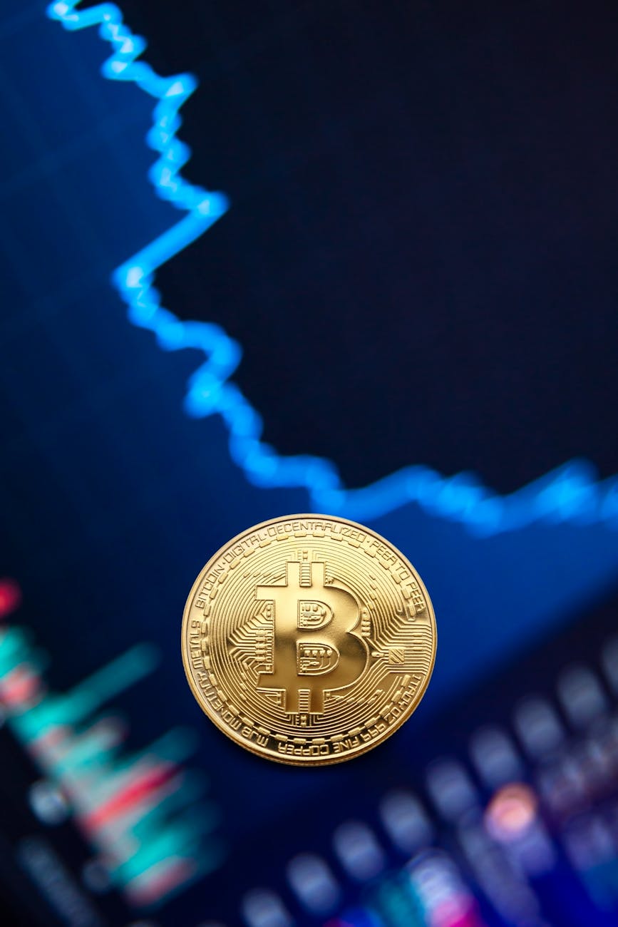Gold Bitcoin coin against a rising market chart