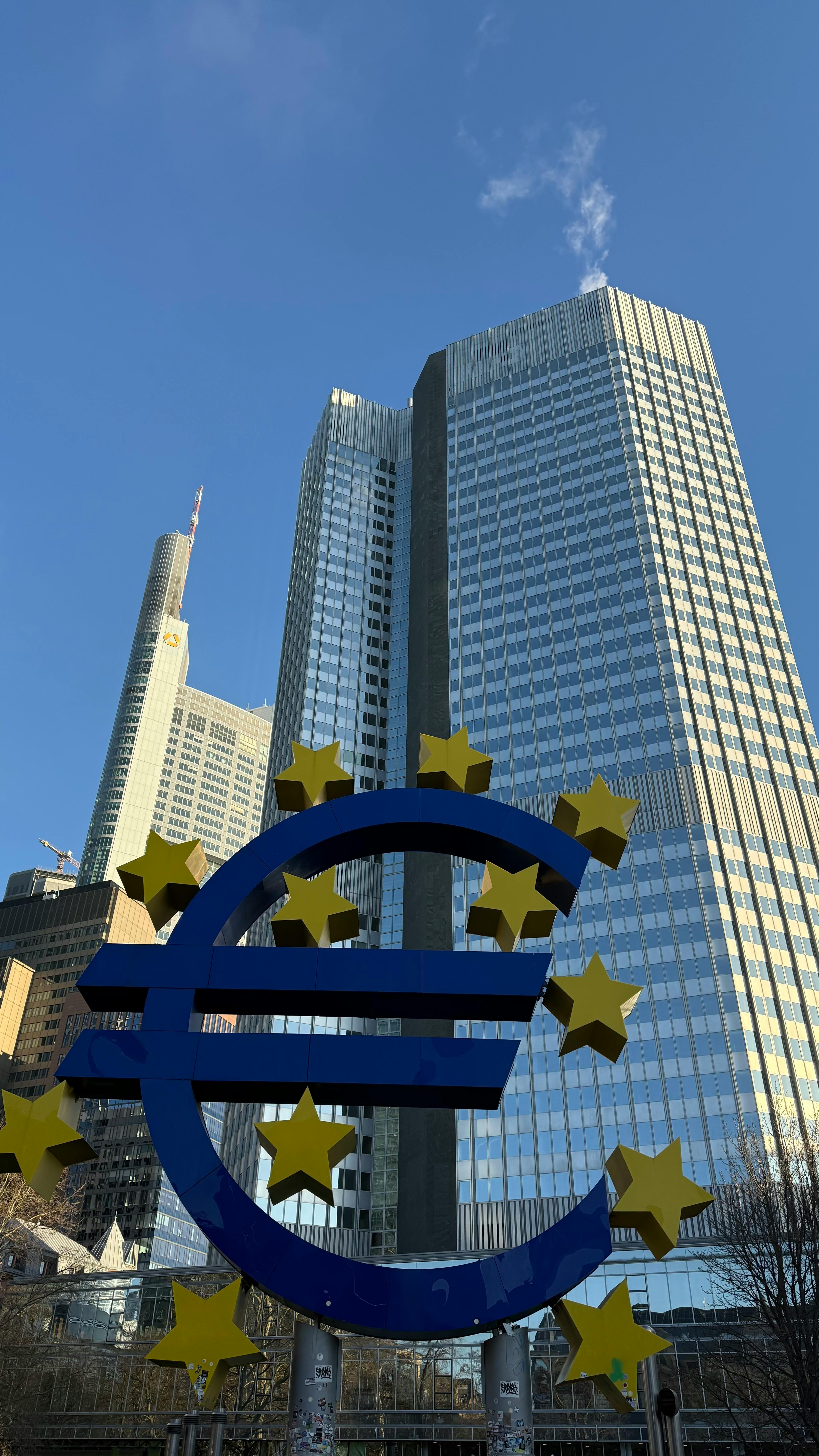 Euro symbol sculpture with Frankfurt financial district skyline