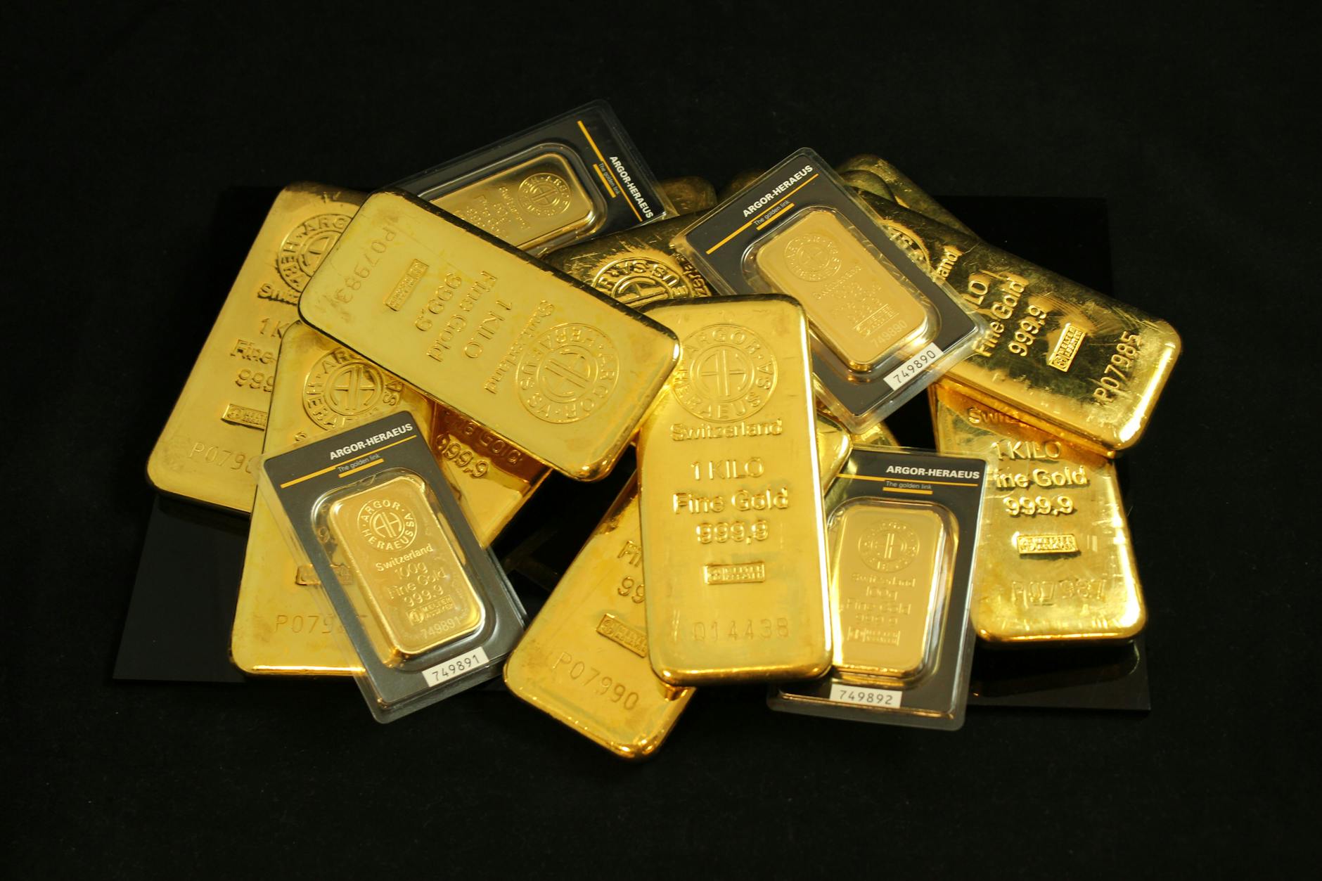 Stacked gold bars on a dark surface, signalling bullion-market strength behind miner earnings