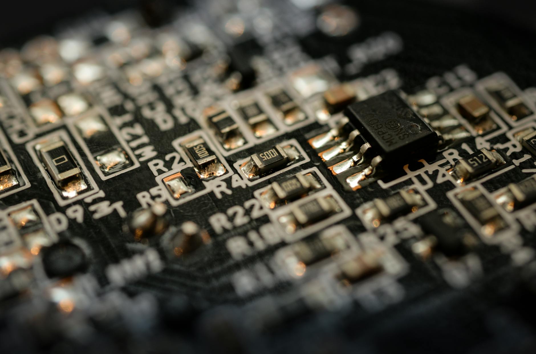 Close-up of a microchip on a circuit board with electronic components and connections