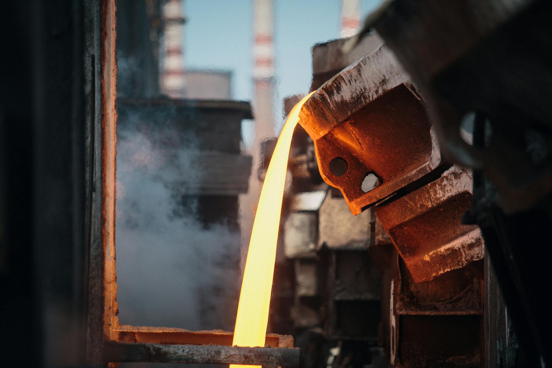 Close-up of molten metal pouring in a foundry, showcasing industrial metal processing