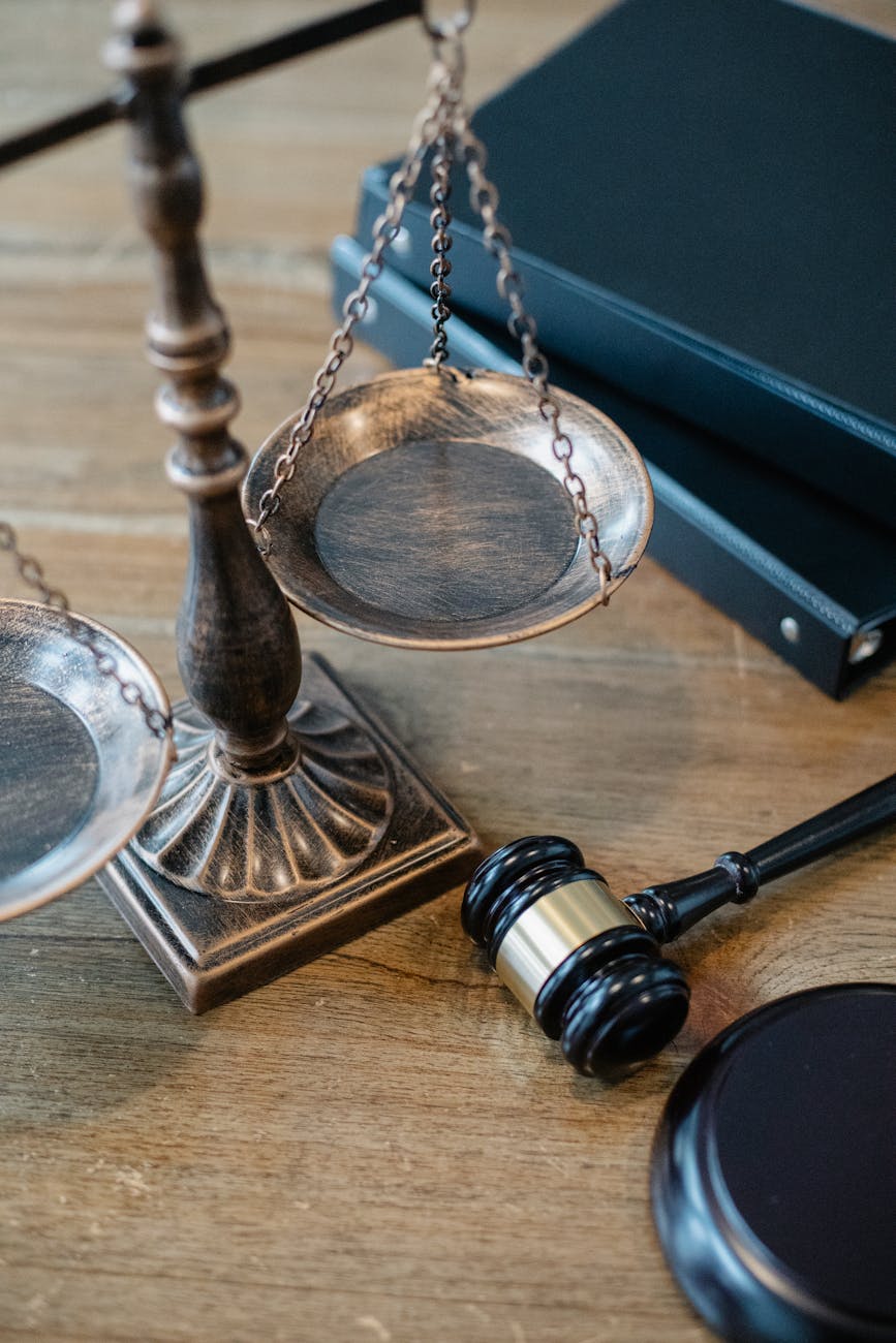 Justice scales and gavel on wooden surface