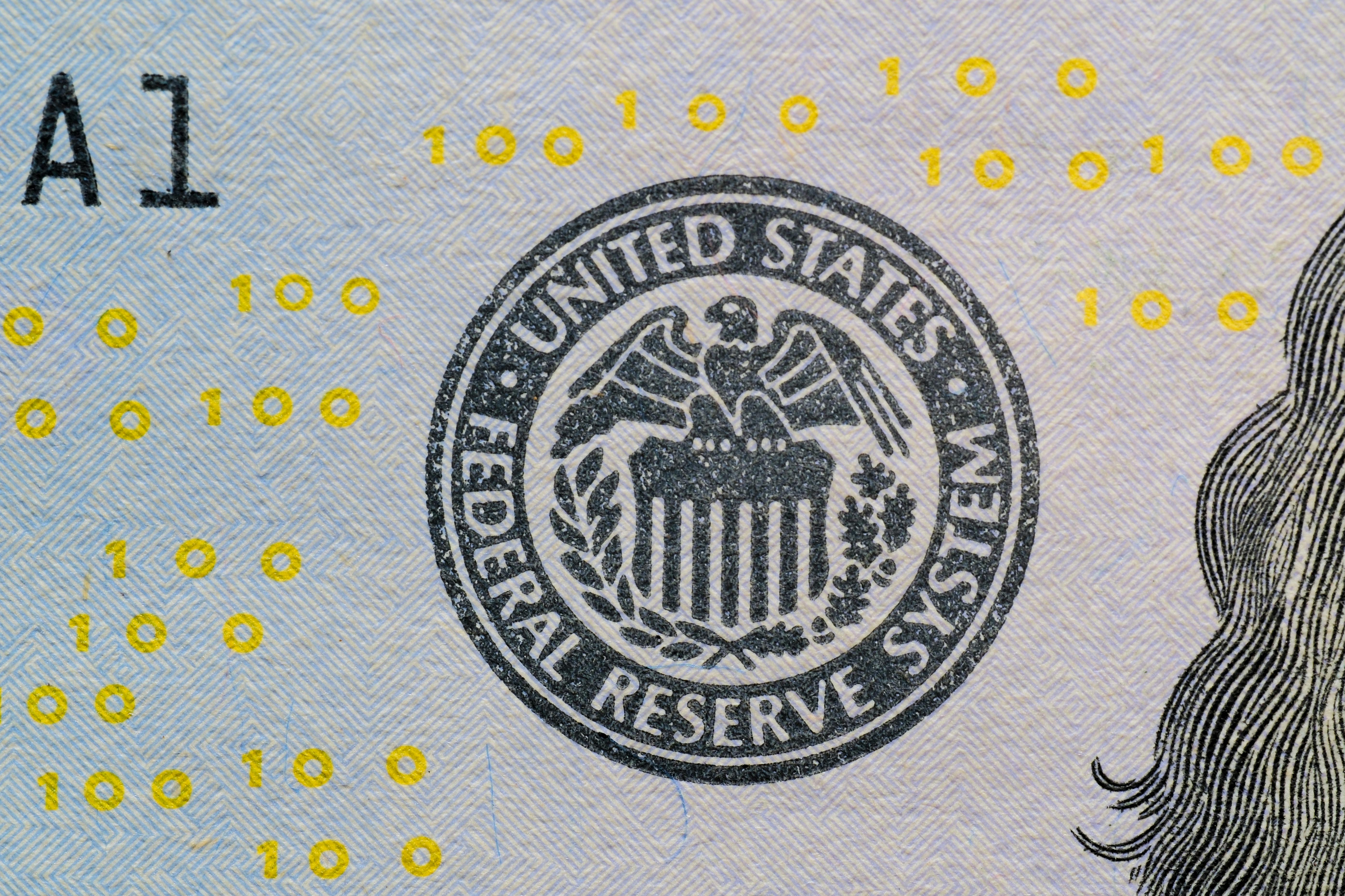 US dollar bills and a DXY index chart showing upward trend