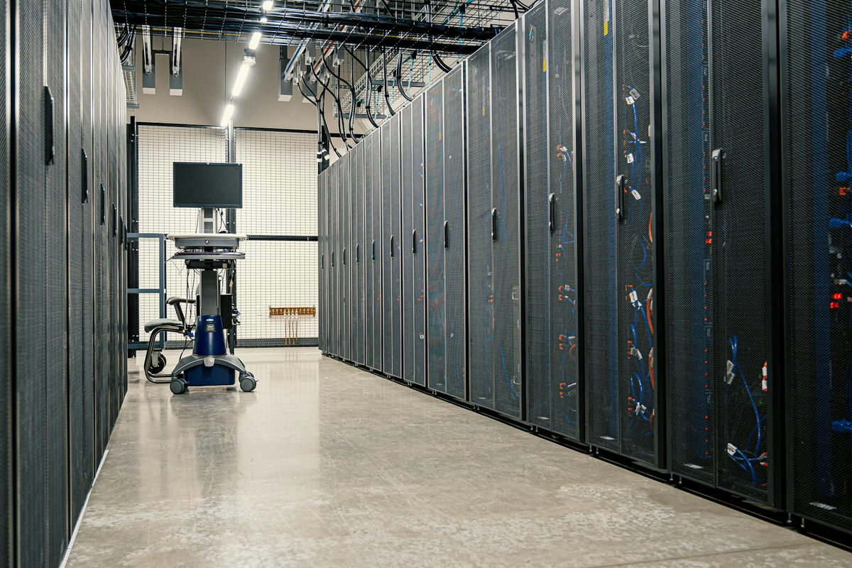 Rows of server racks in a data center, illustrating the infrastructure spending behind AI compute demand.