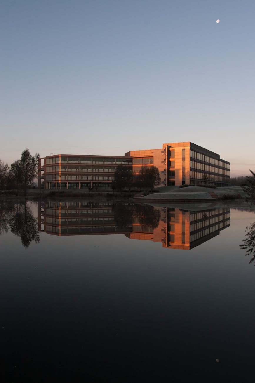 Modern office building reflected in a calm lake
