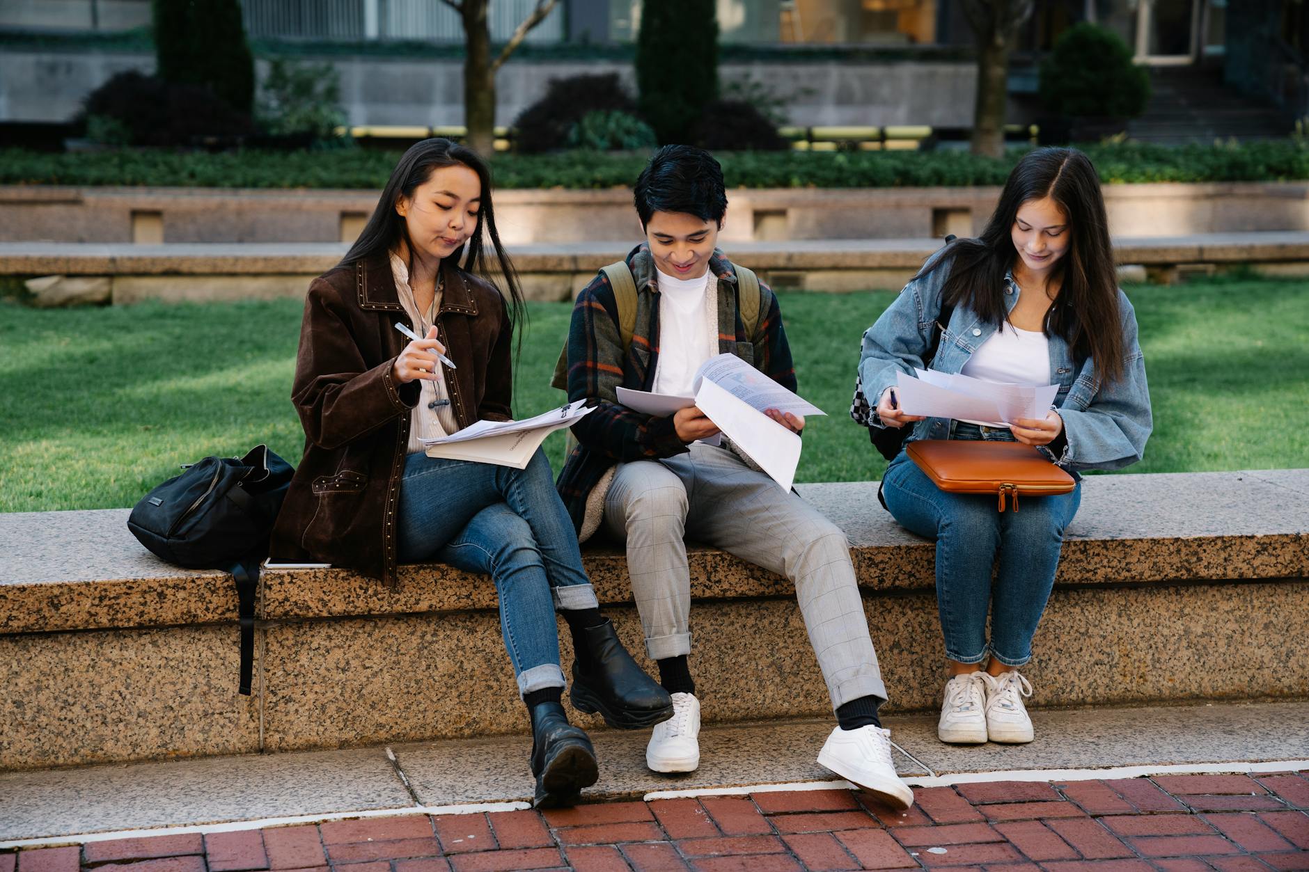 College students reviewing coursework on campus as federal borrowing costs reset for the next academic year.