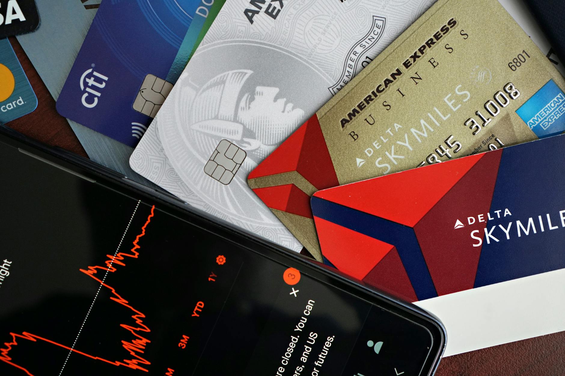Credit cards and household bills on a desk, illustrating the strain in consumer balance sheets.