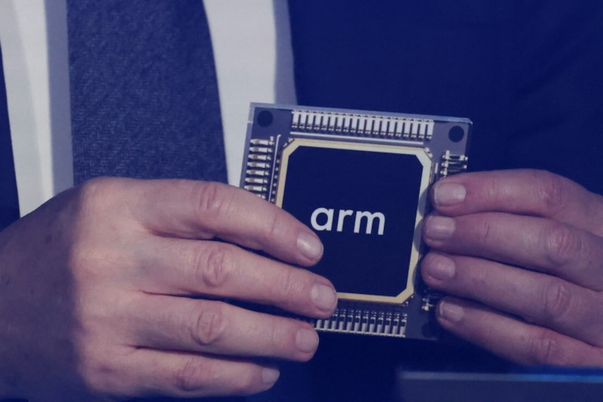 Rene Haas holds a replica of an Arm chip