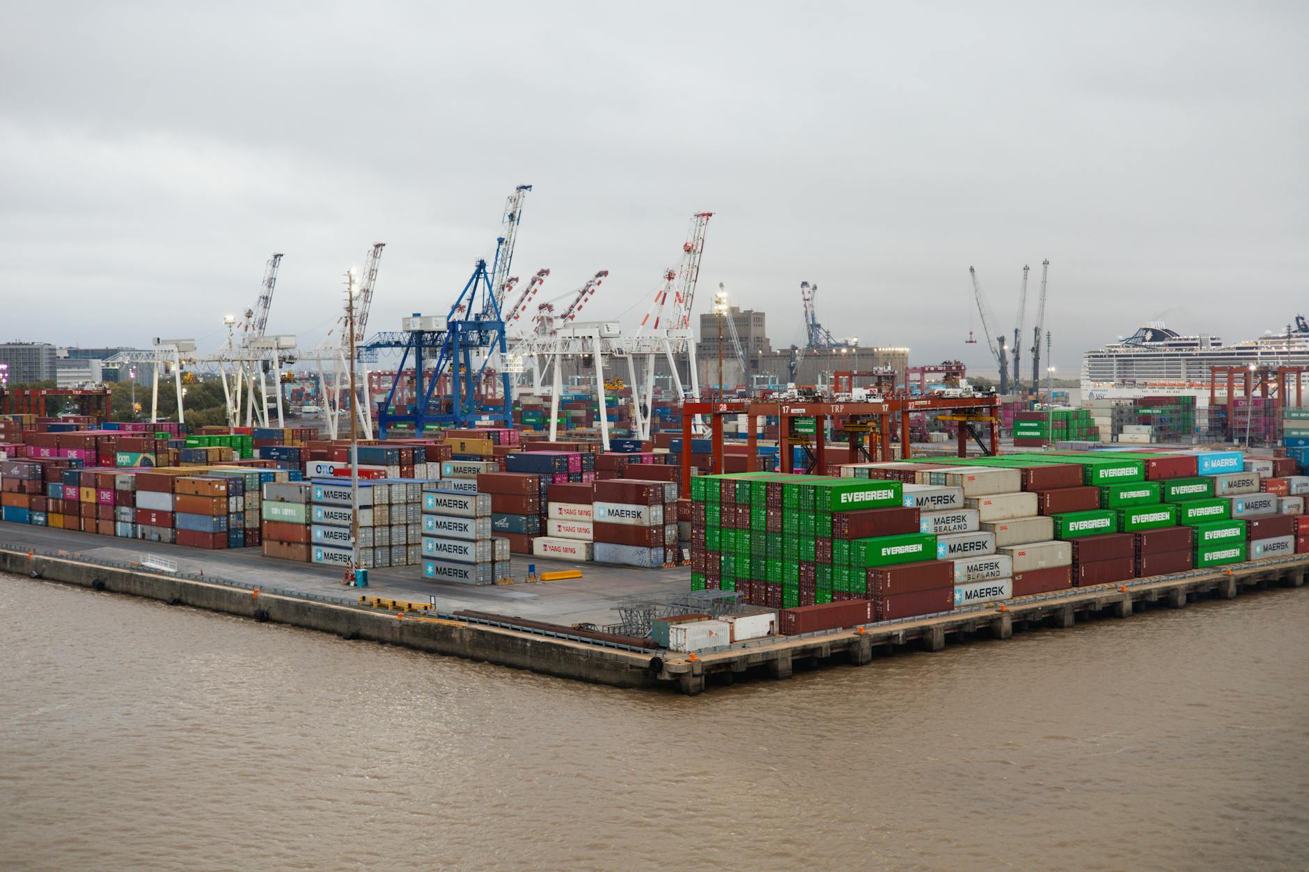 Shipping containers stacked at a cargo port, illustrating the global freight equipment market at the center of the DOJ cartel case.