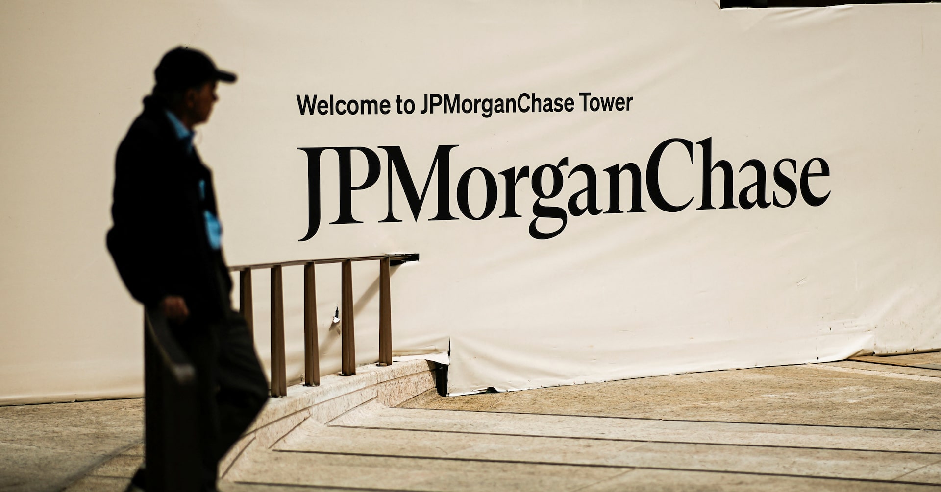 A person waits near one of the entrances of the JPMorgan Chase & Co. headquarters in New York City.