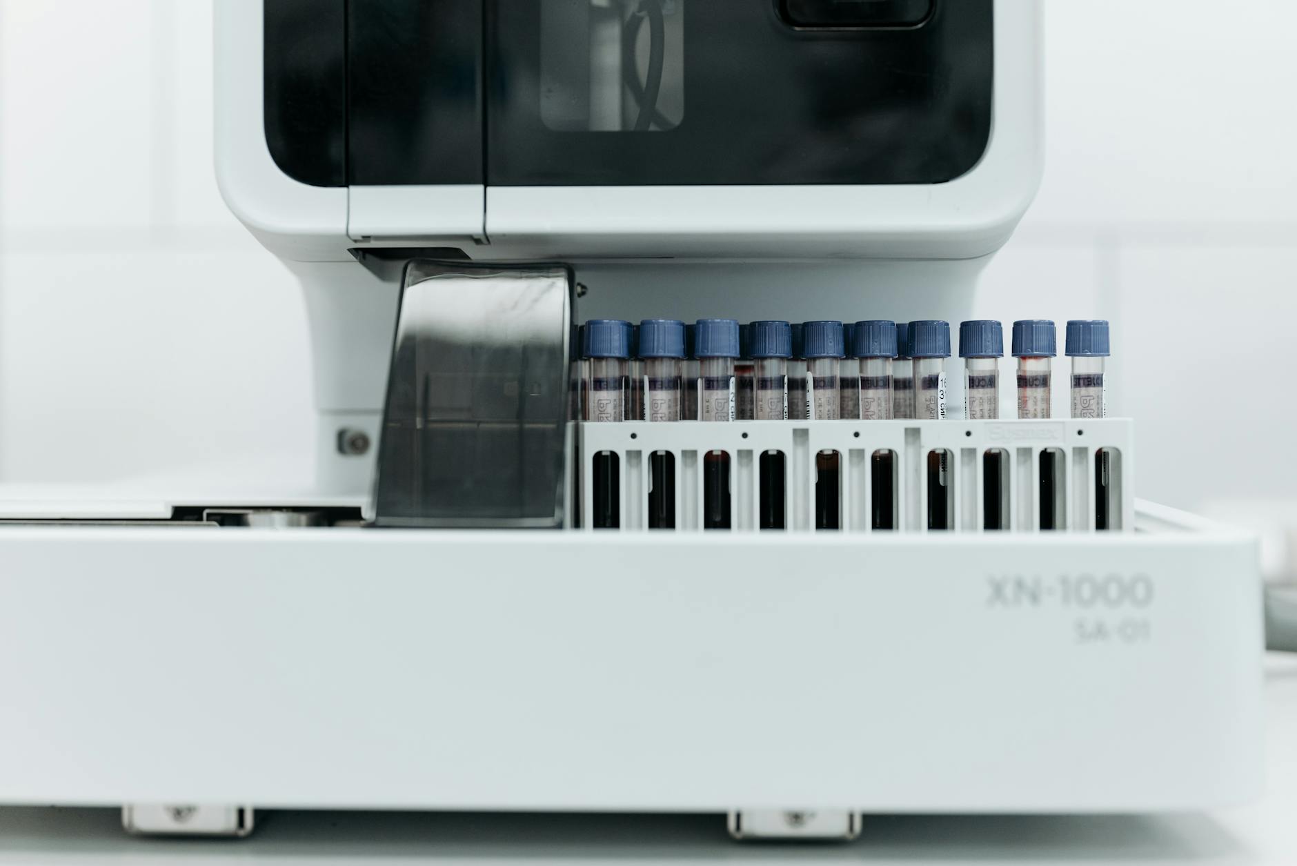 Close-up of laboratory machine holding test tubes for analysis.