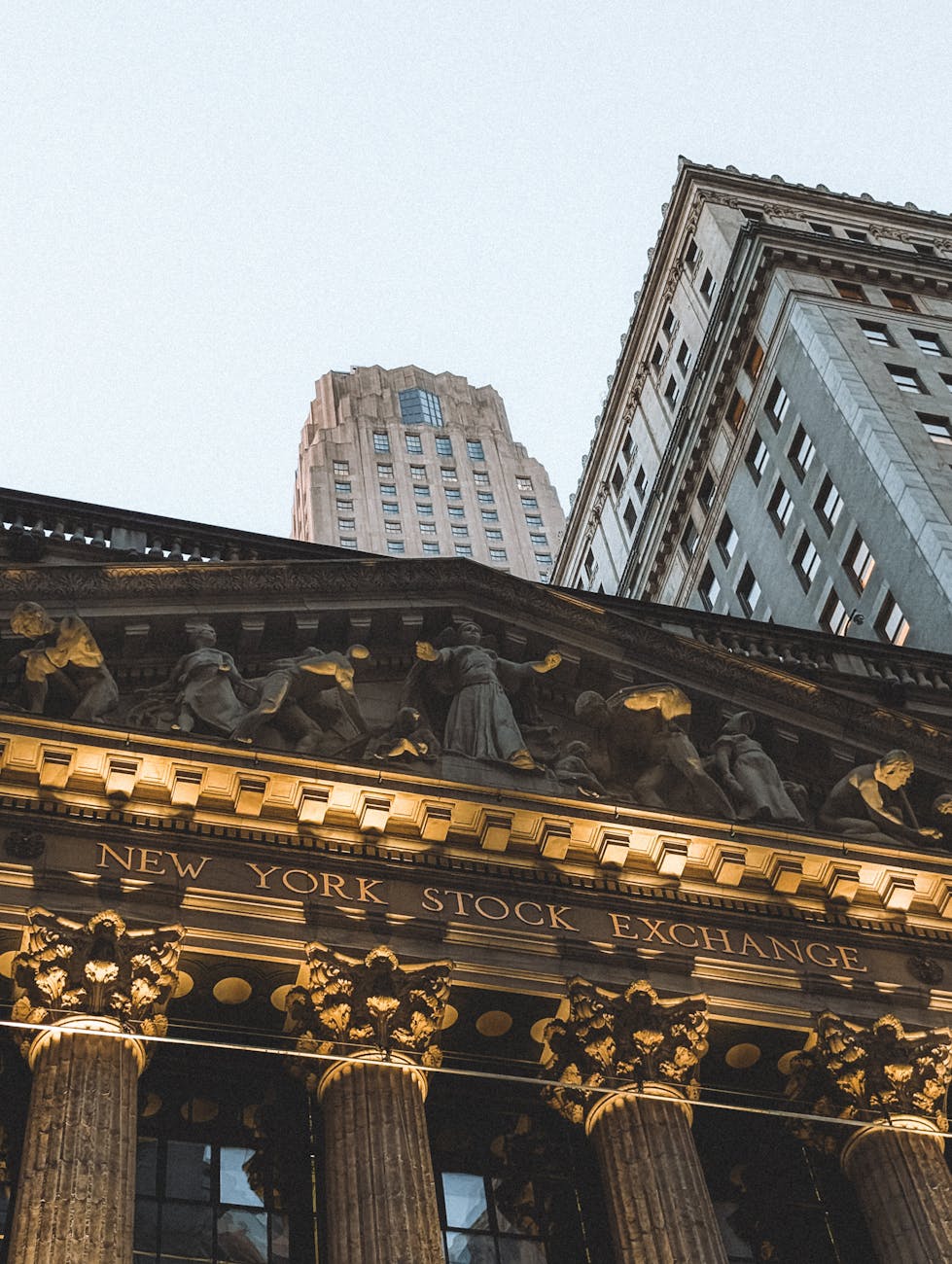 New York Stock Exchange facade at dusk as regional bank IPO activity picks up.