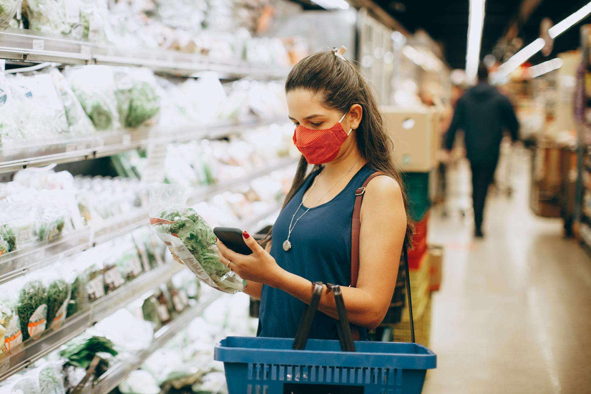 Shopper checks grocery items in a supermarket as food-price pressures weigh on household budgets.