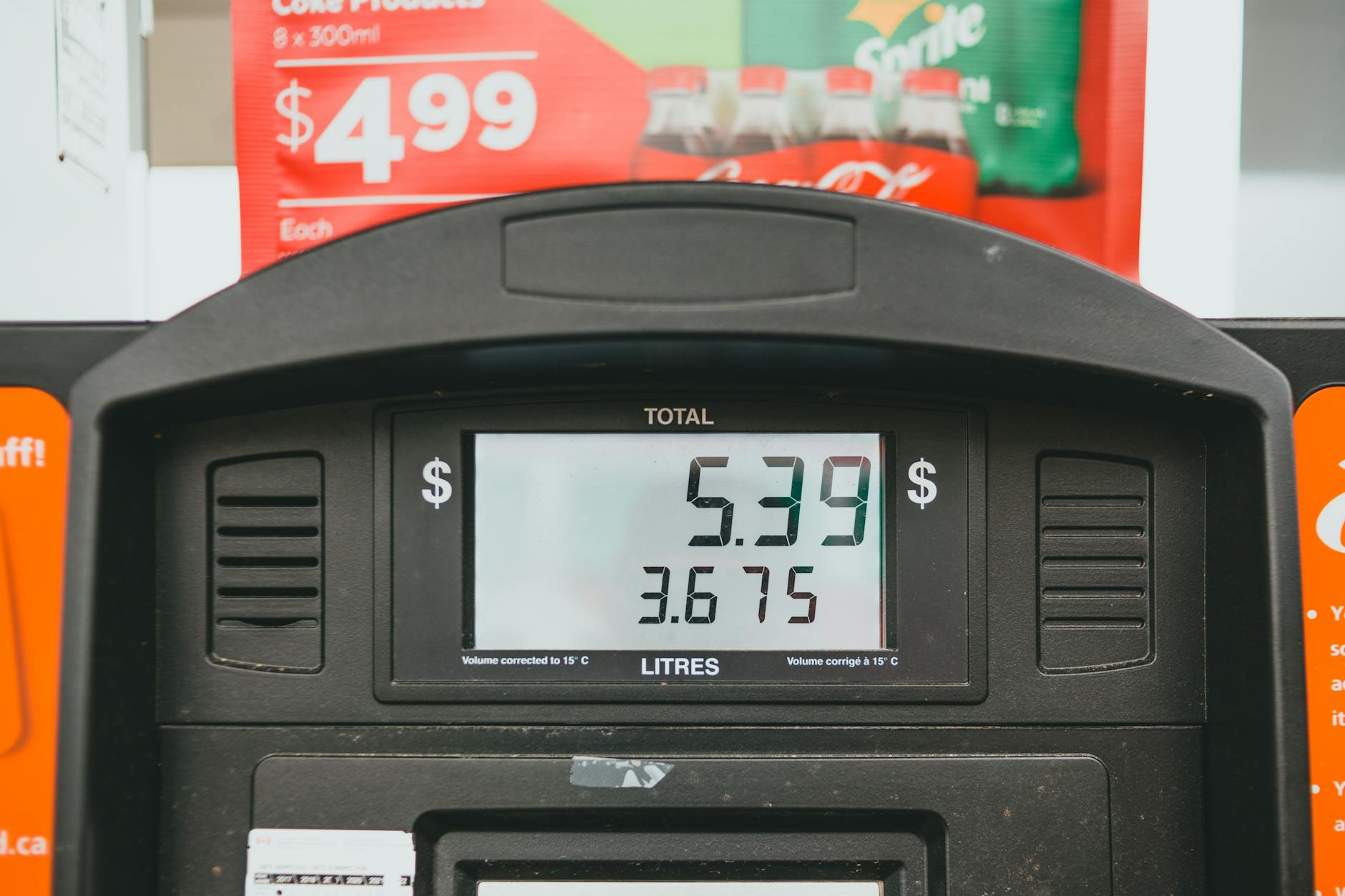 Gas pump display showing fuel price and volume totals, a reminder of how energy shocks hit consumers first and can then bleed into wider spending patterns.