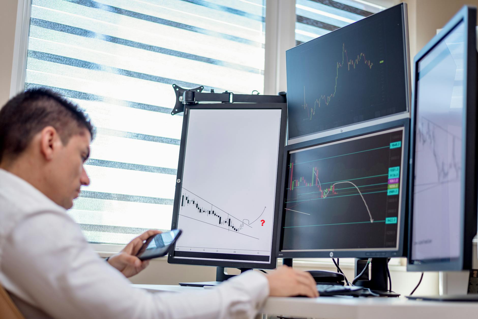 Trading screens tracking Treasury yields as traders reprice the Fed path after Kevin Warsh's arrival