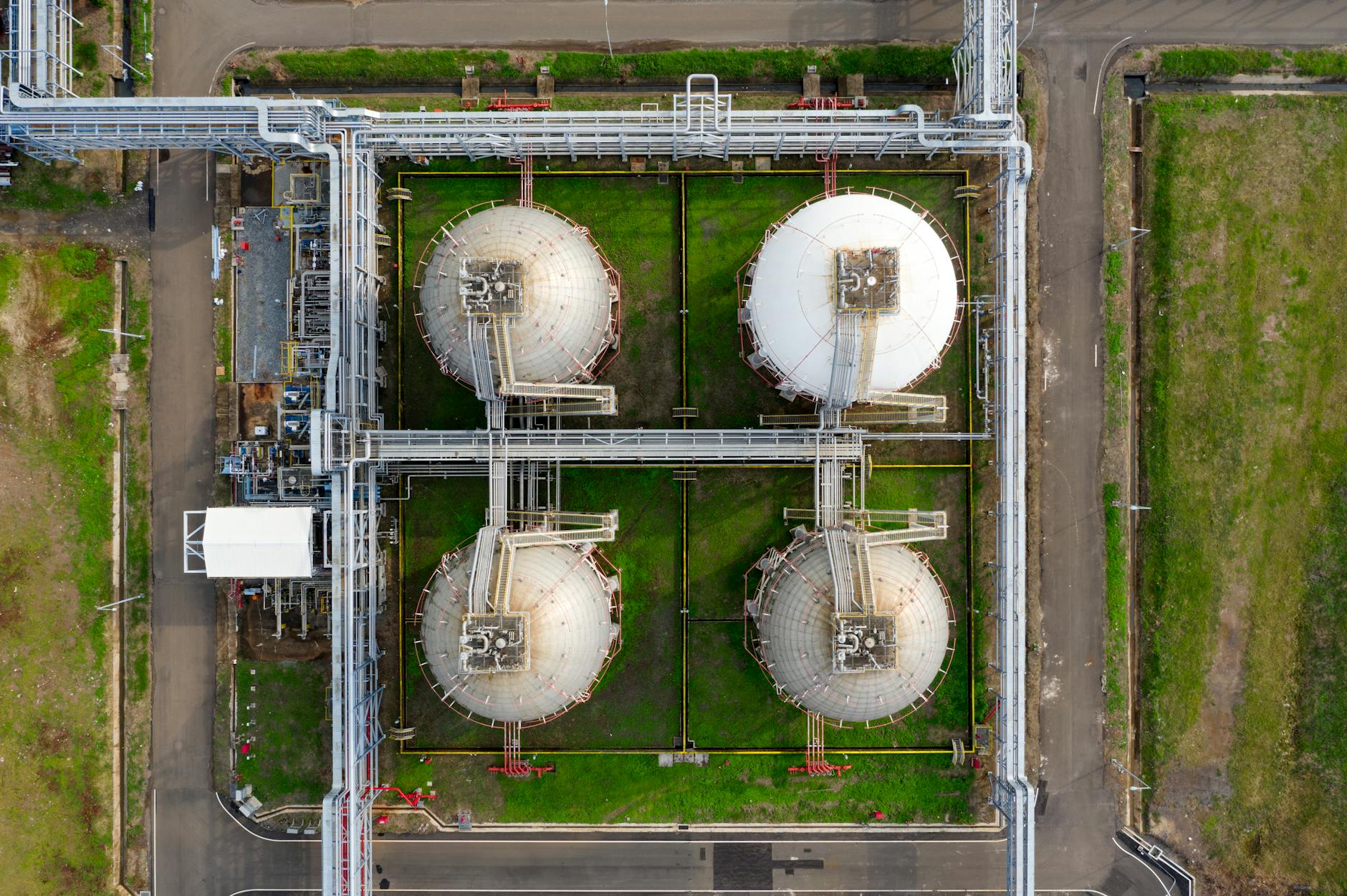 Oil storage tanks and refinery infrastructure illustrating depleted inventories and physical-market tightness