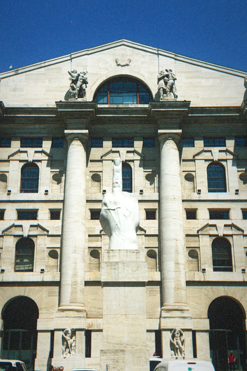 Maurizio Cattelan's L.O.V.E. sculpture stands outside Palazzo Mezzanotte, home of the Borsa Italiana, in Milan.