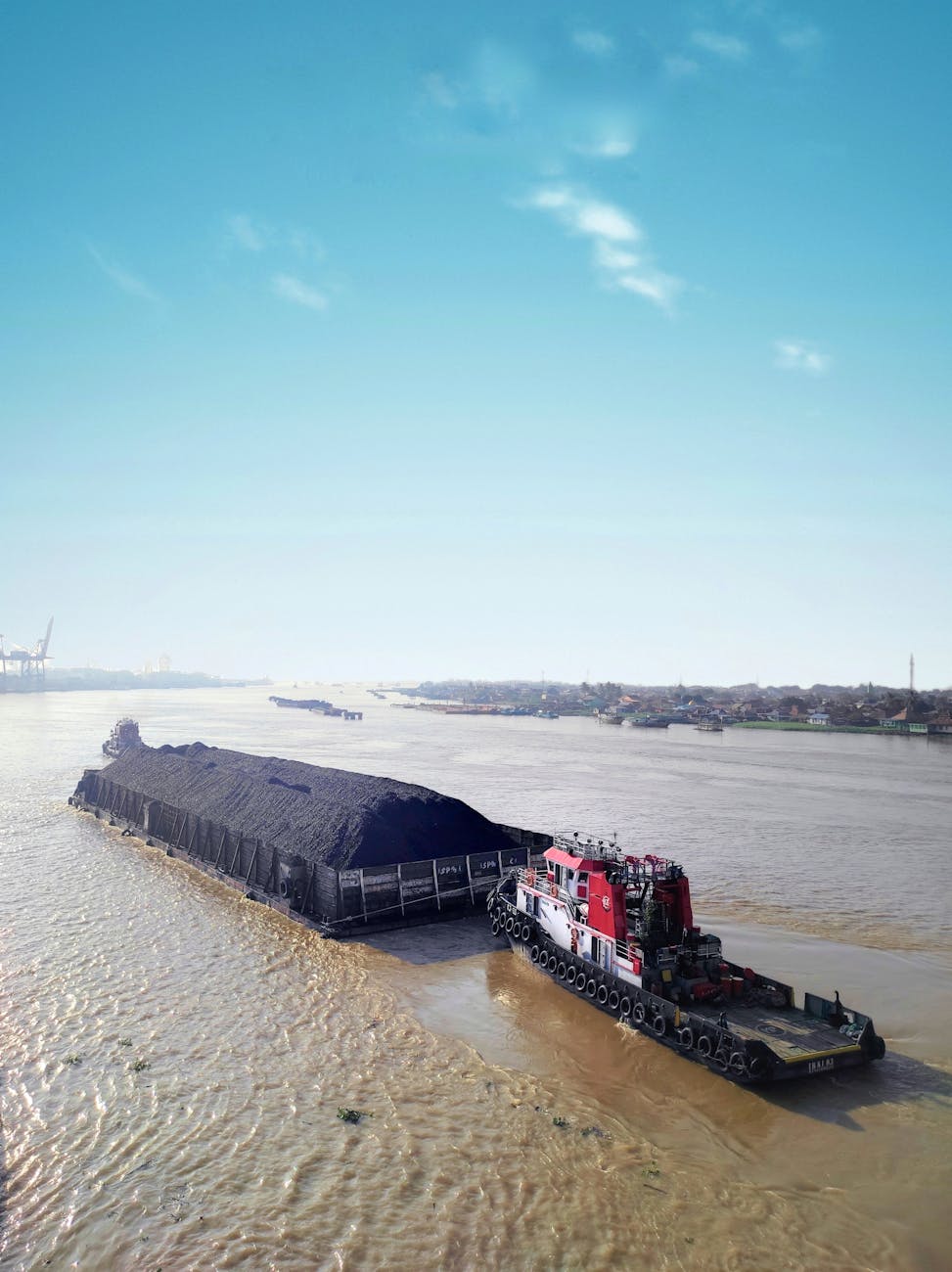 A cargo barge on the Musi River in Indonesia, illustrating the shipping routes at stake in Jakarta's export overhaul.