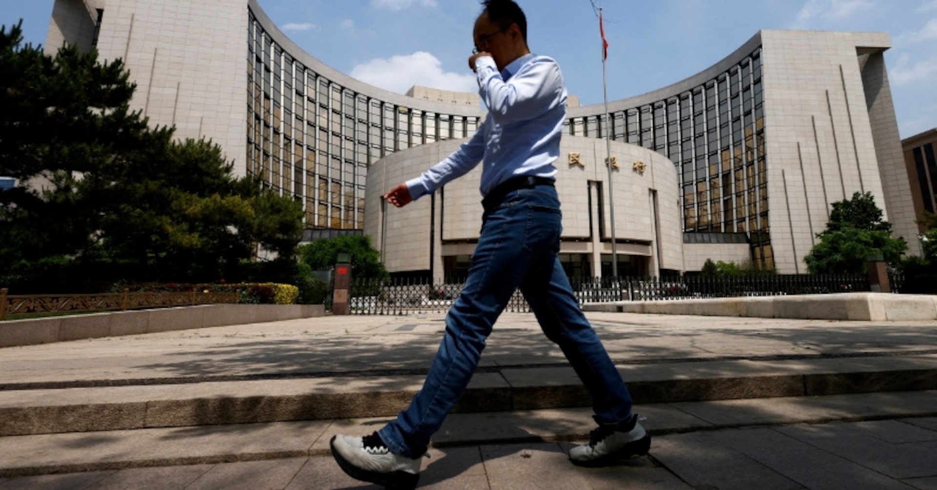 A man walks past the headquarters of the People's Bank of China, in Beijing, China May 7, 2025.