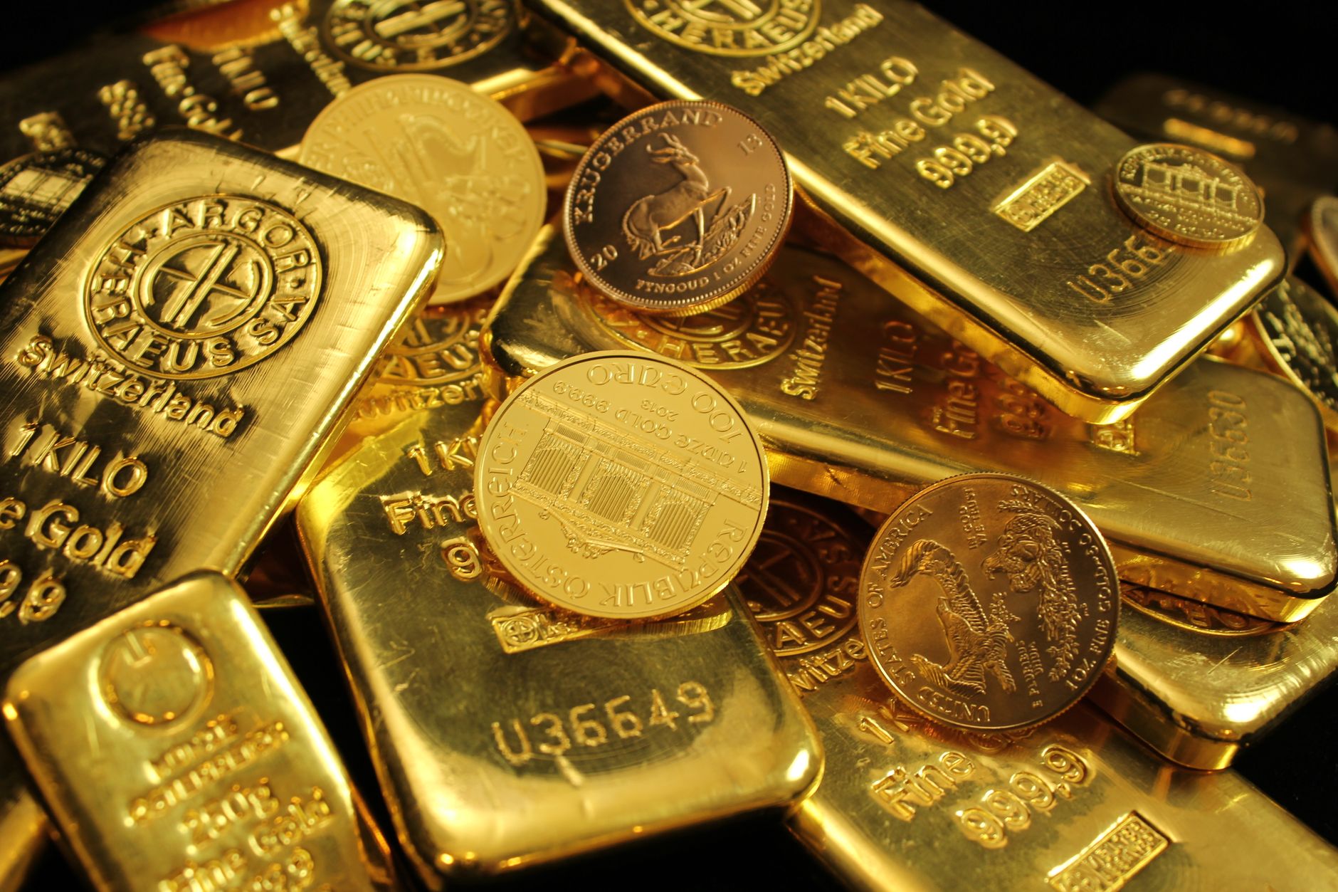 Gold bars stacked on a dark surface