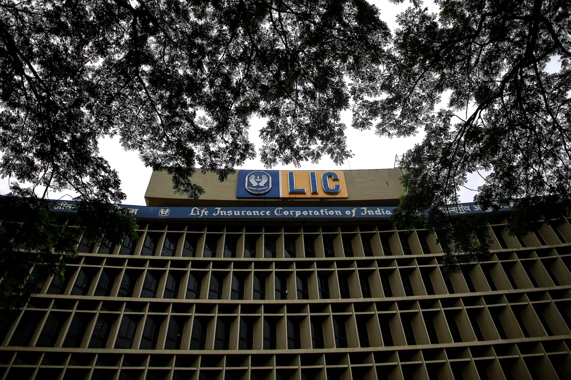 A security guard walks past logos of Life Insurance Corporation of India (LIC) and Bombay Stock Exchange (BSE) inside the BSE building in Mumbai, India, May 17, 2022. REUTERS/Niharika Kulkarni/File Photo