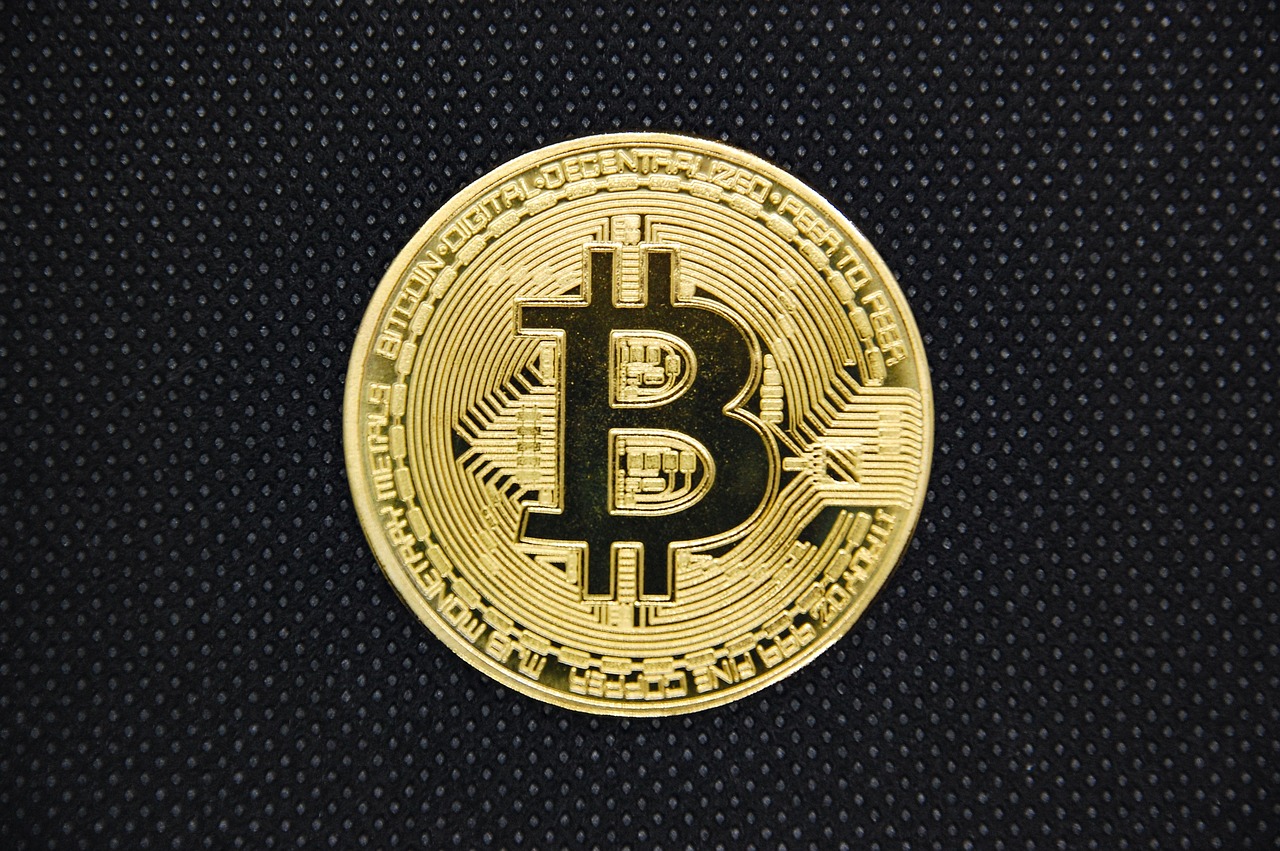 Bitcoin token imagery alongside market graphics to illustrate crypto's place in a cross-asset rotation.