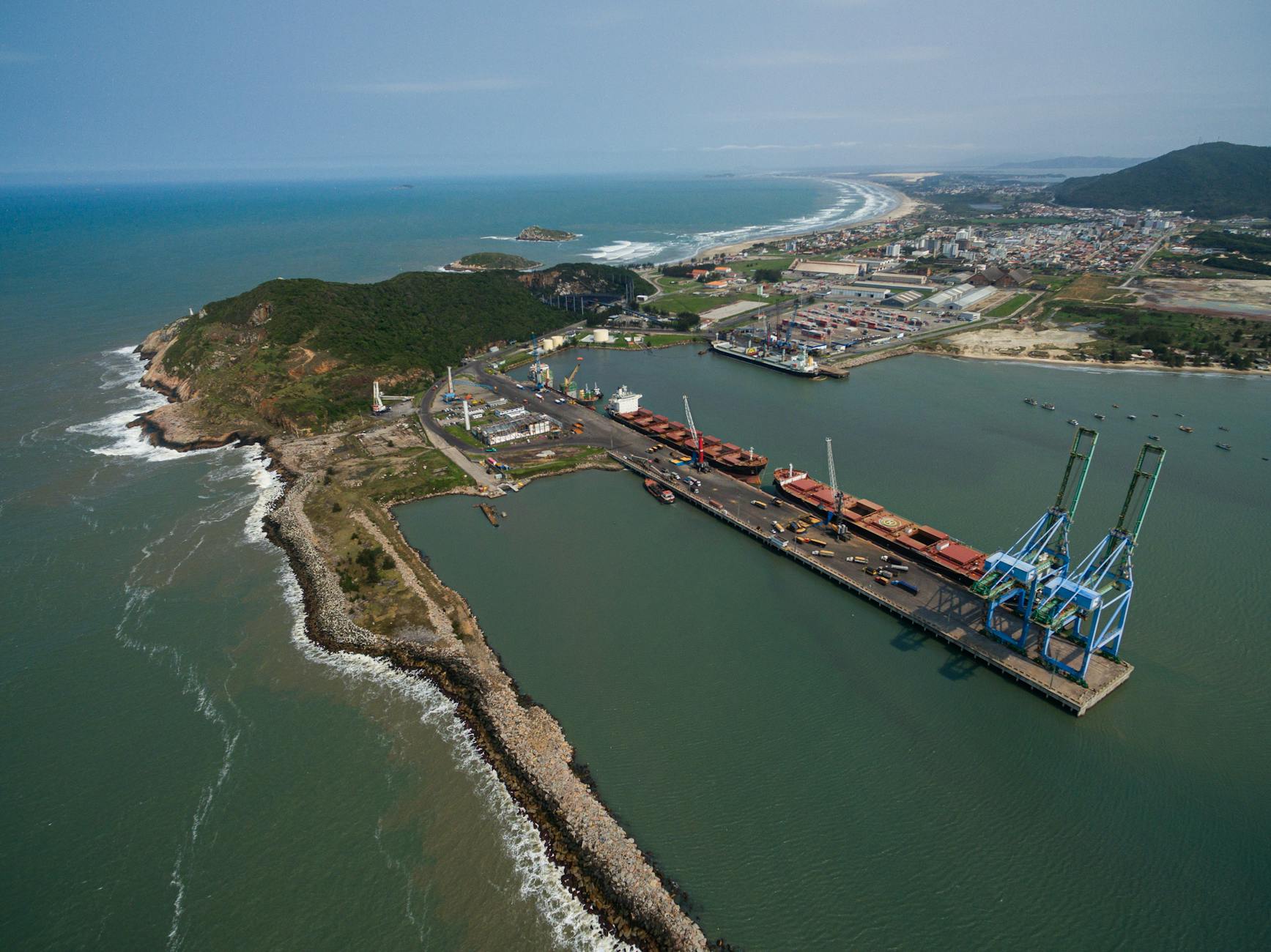 Aerial view of a Brazilian port with cargo docks and cranes