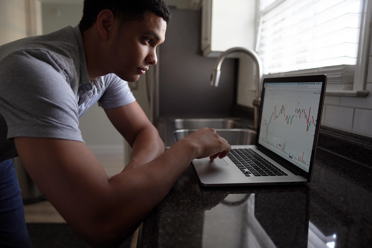 Trader reviews market screens as private-markets shares sell off on redemption pressure
