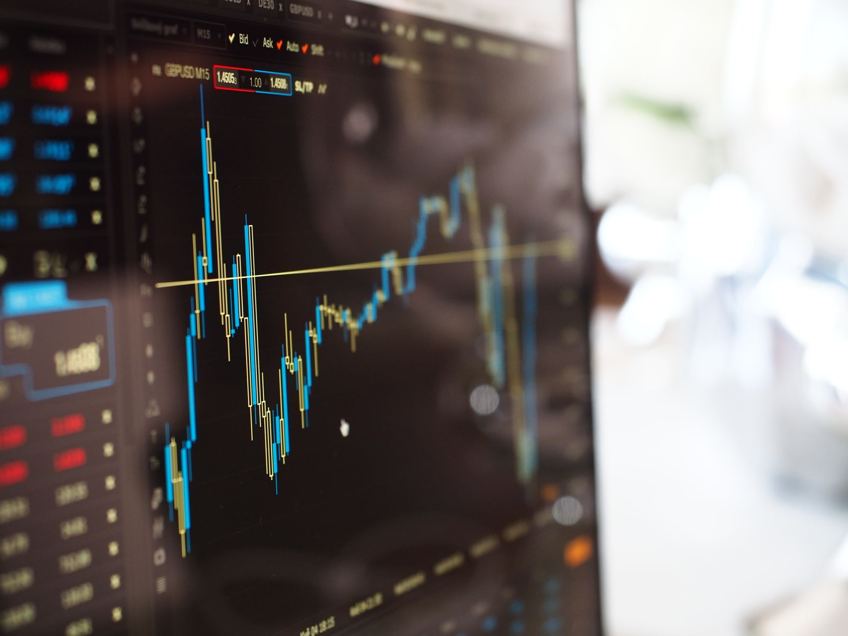 Financial market charts on a trading monitor as Treasury yields move higher
