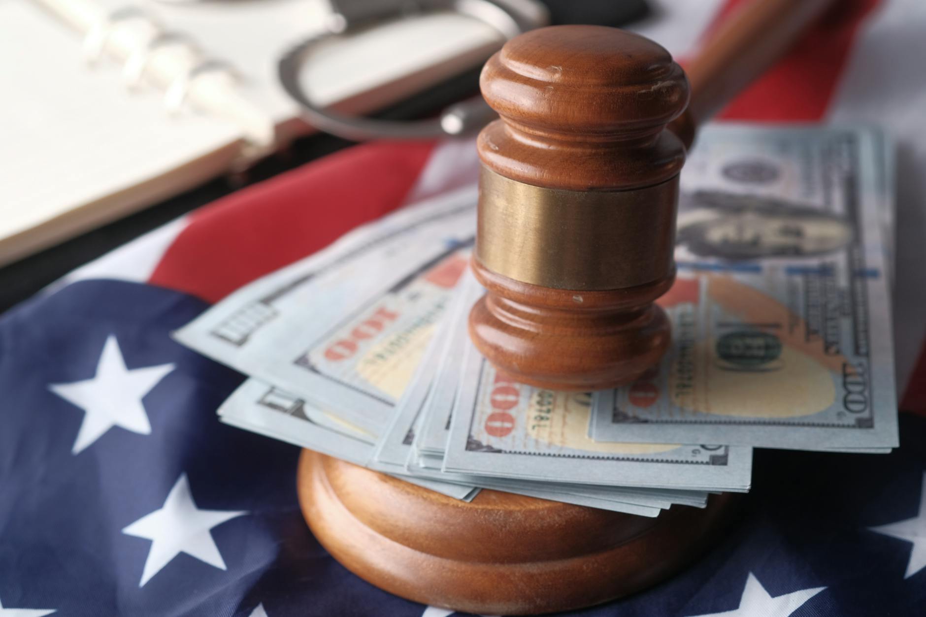 A judge's gavel rests on US dollar bills, reflecting the finance and fraud-enforcement context of the Prophecy case.