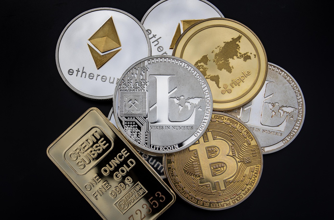 Cryptocurrency tokens beside a gold bar, reflecting the digital-gold trade under stress.