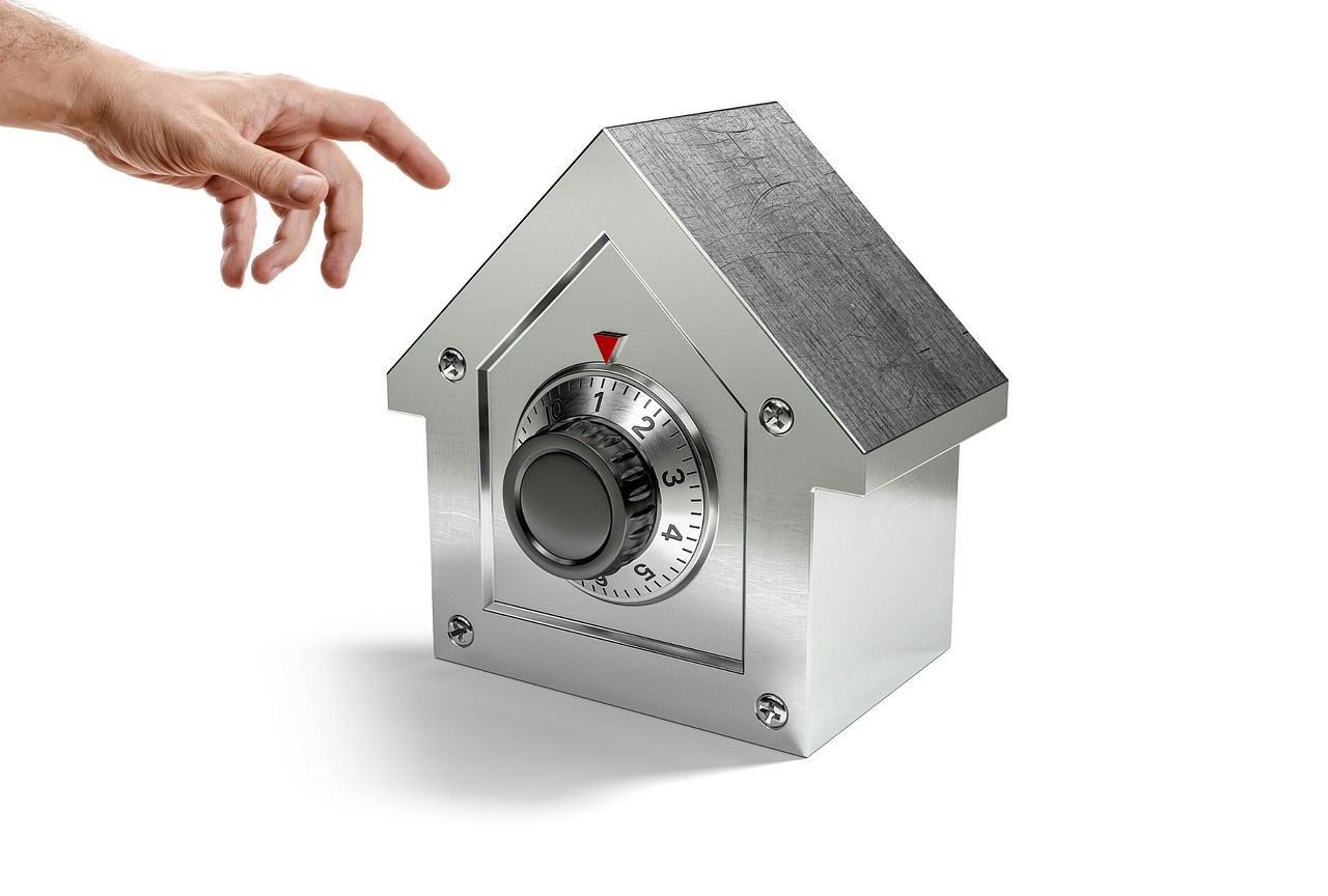Padlock and house key illustrating real-estate fraud risk.