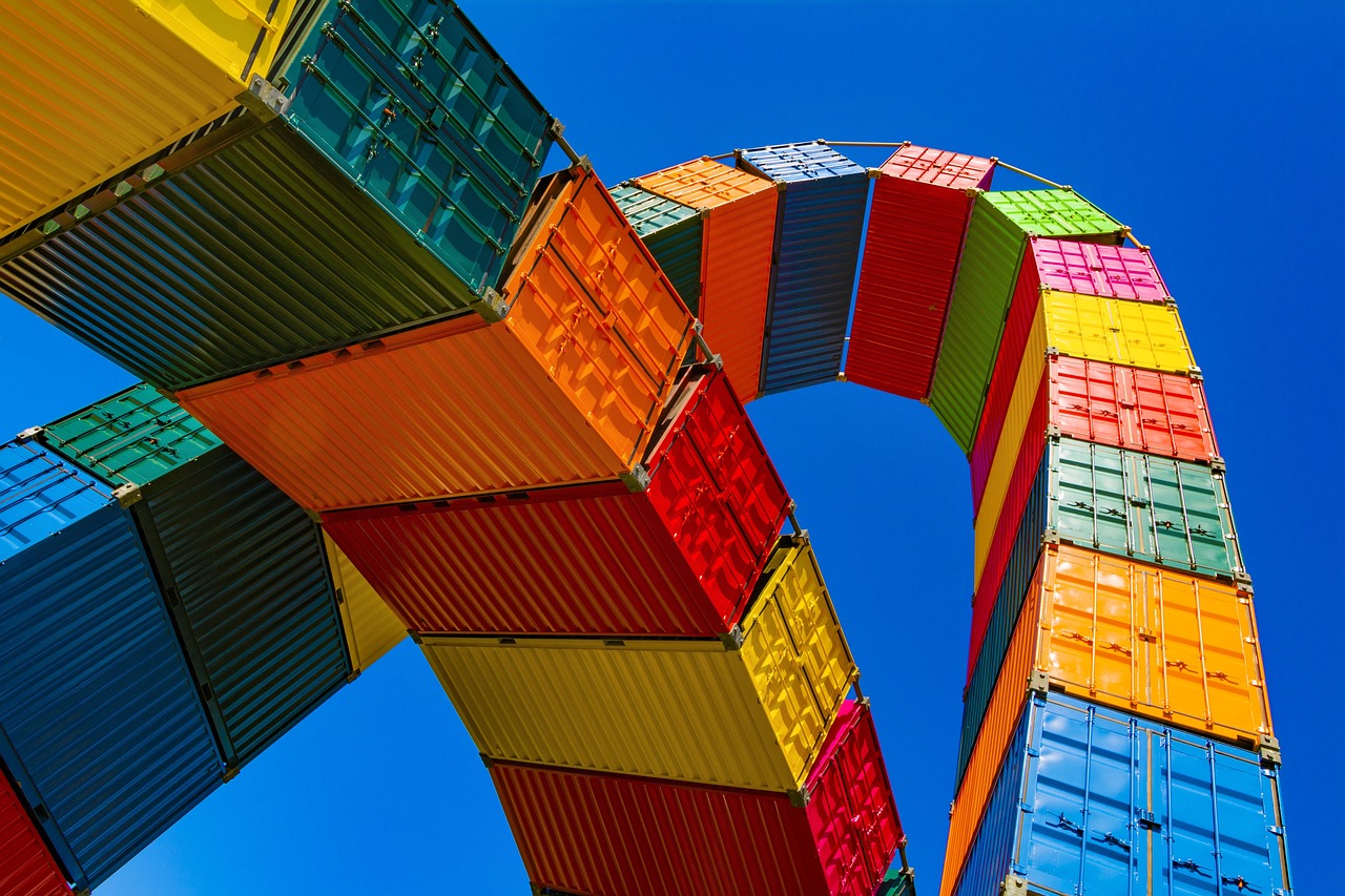 Rows of shipping containers stacked in a freight yard, reflecting cross-border North American trade.