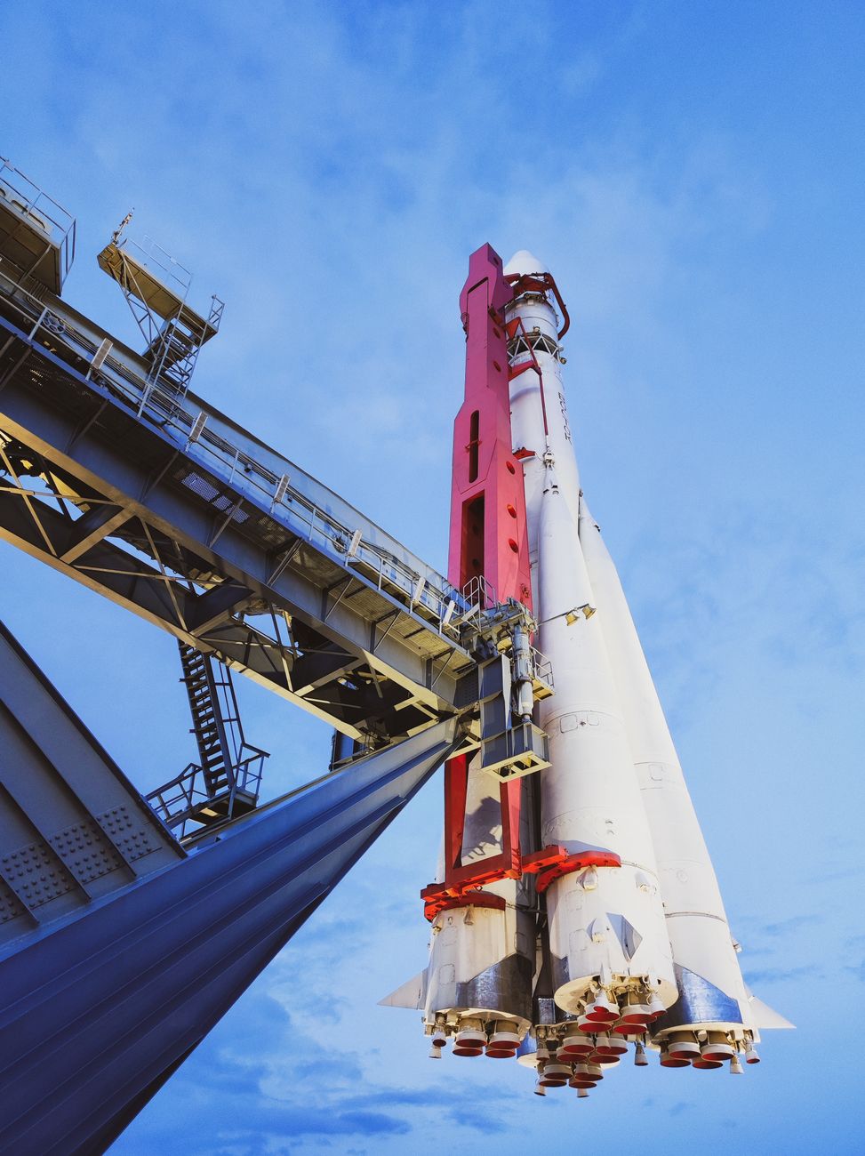 A rocket stands at a launch pad under a bright blue sky, underscoring the industrial scale behind SpaceX's public-market debut.