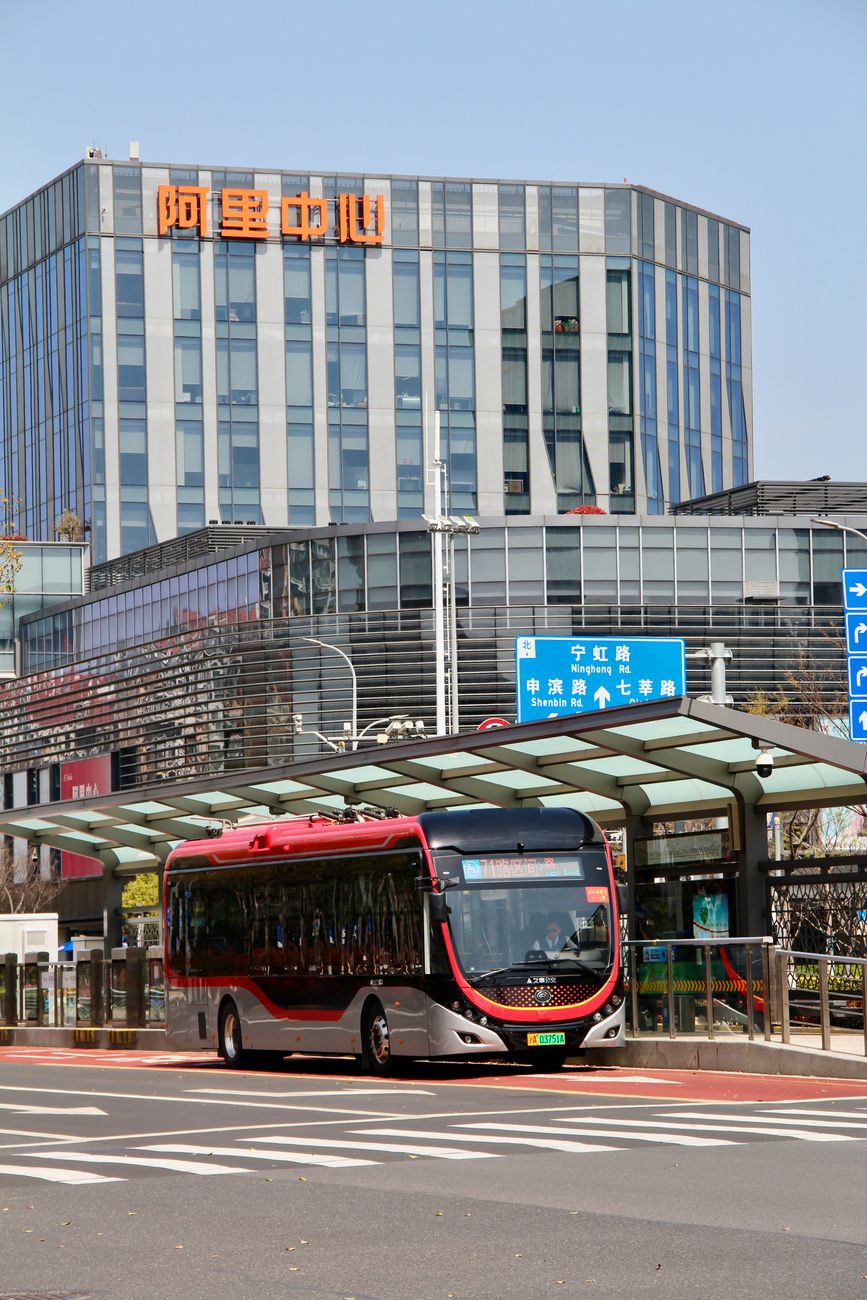 Electric bus in front of Alibaba building in Shanghai