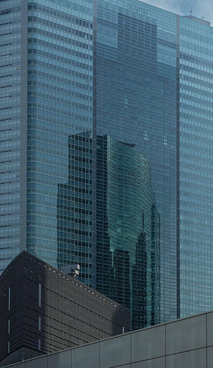 Tokyo skyline with high-rise commercial buildings under clear skies.