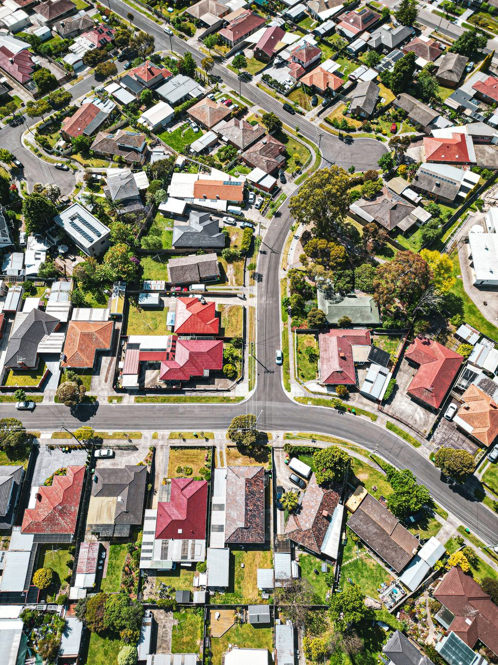 Drone view of suburban houses and streets in Melbourne, illustrating Australia's residential property market.