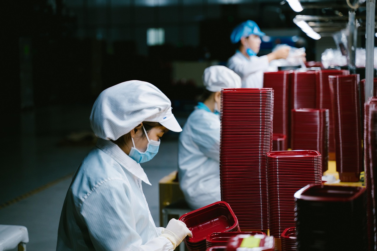 Masked factory worker in an Asian manufacturing plant
