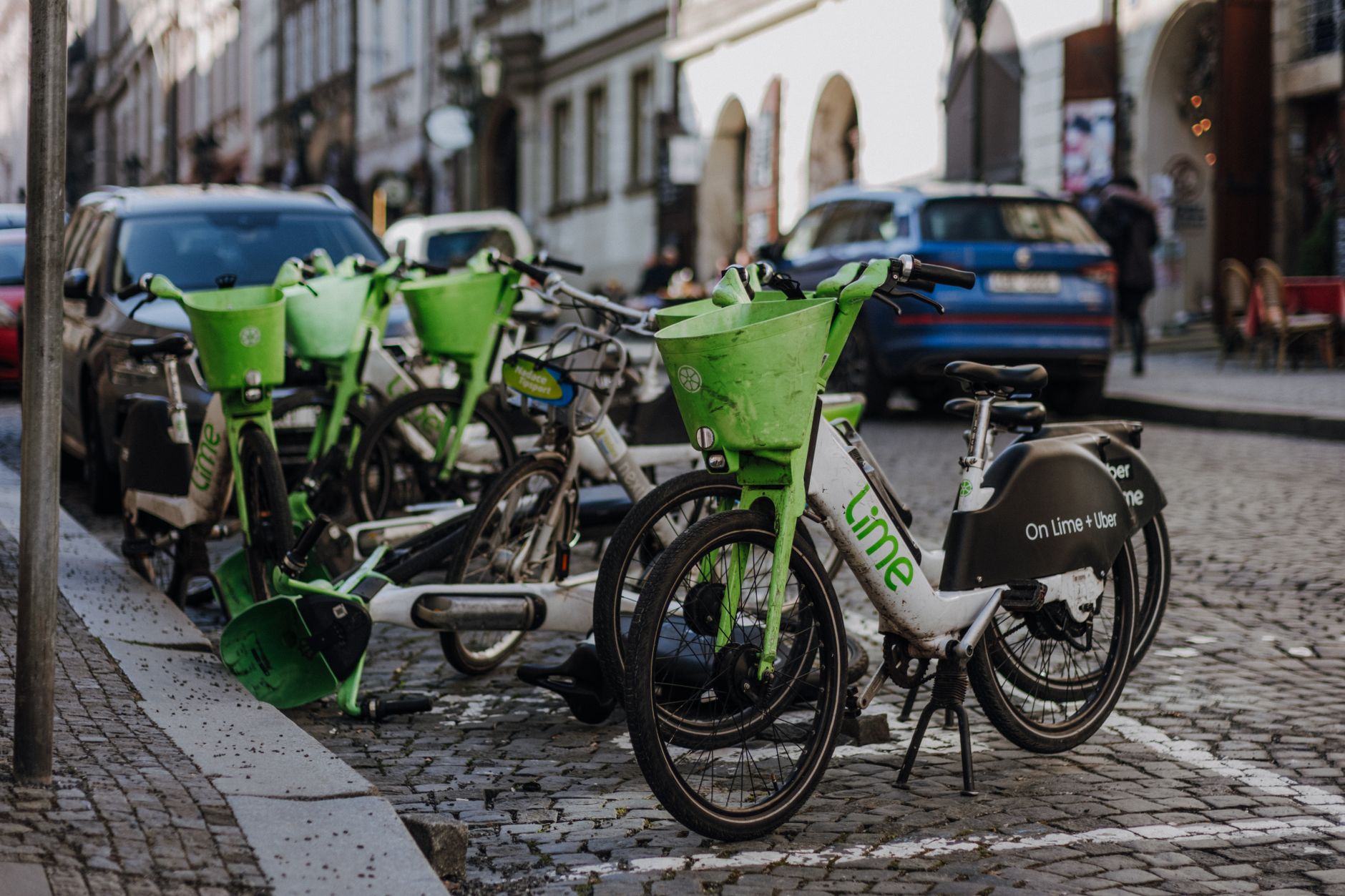 Lime electric bikes lined up on a city street.