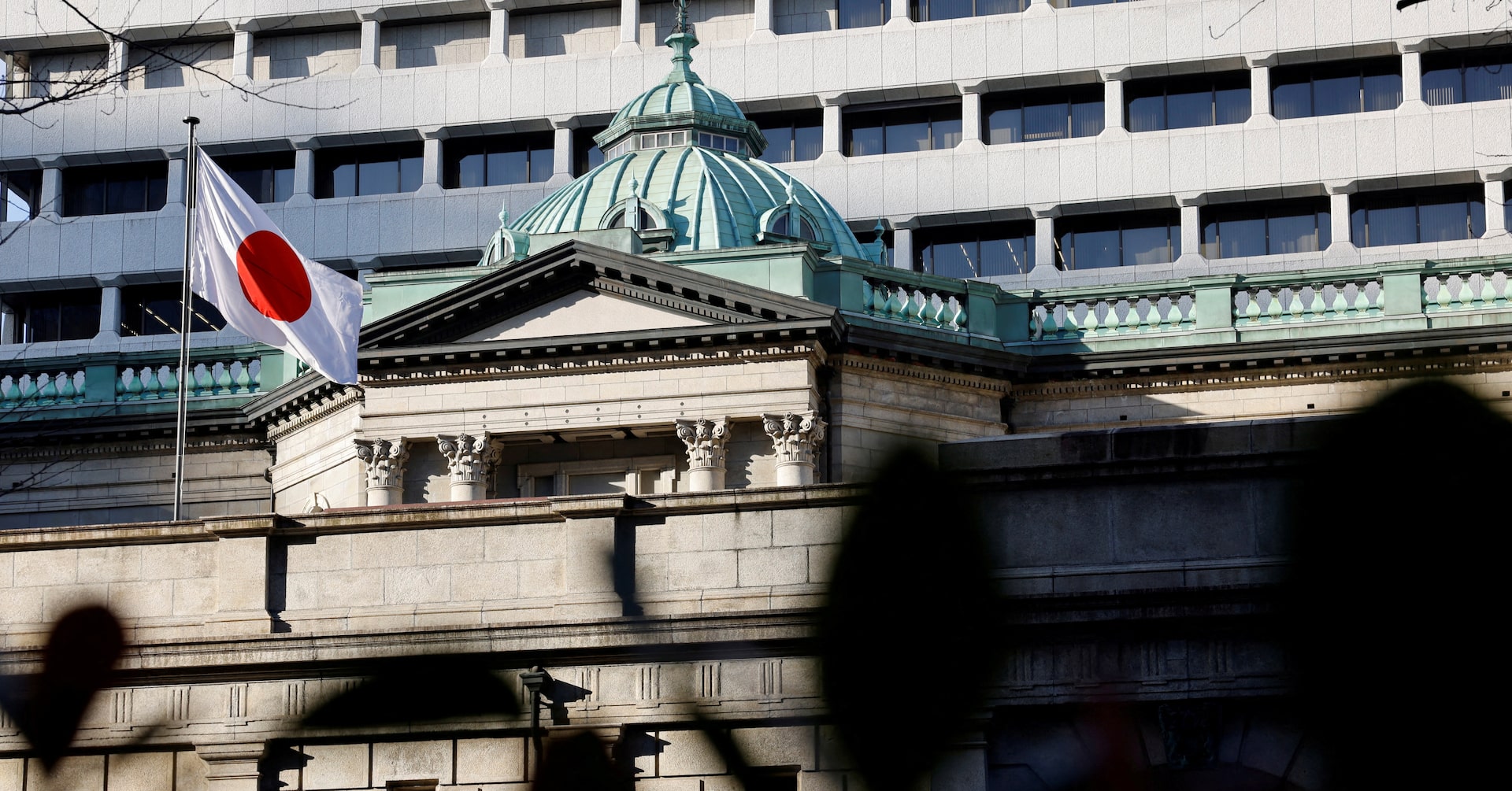 A Japanese flag flutters atop the Bank of Japan headquarters in Tokyo, Japan, December 19, 2025.
