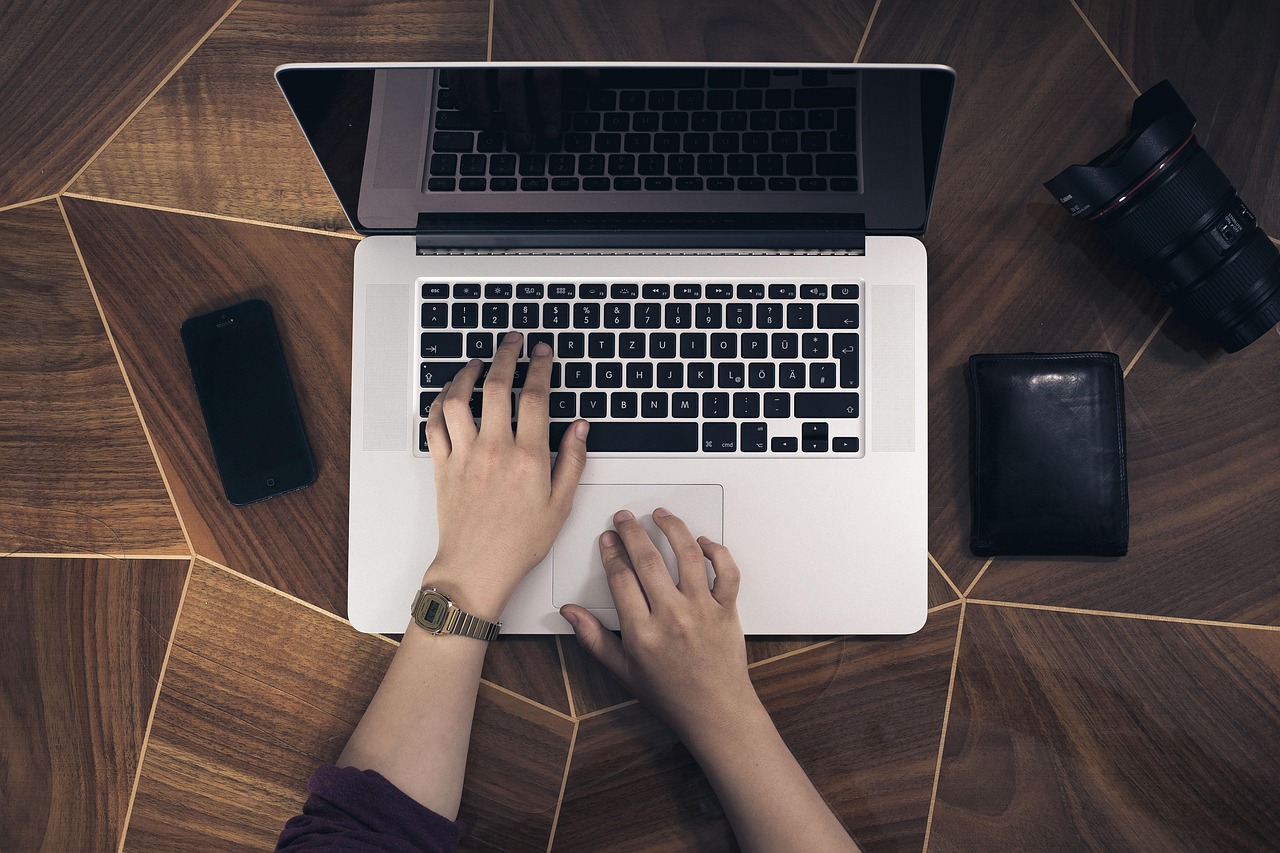 Apple laptop and iPhone on a desk