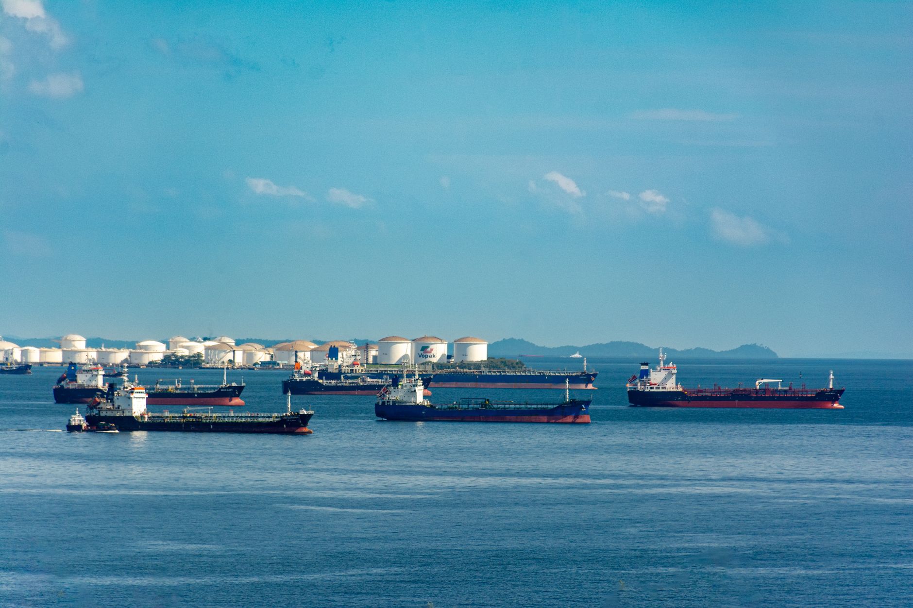 Fuel storage tanks and refinery infrastructure illustrating energy-market supply constraints