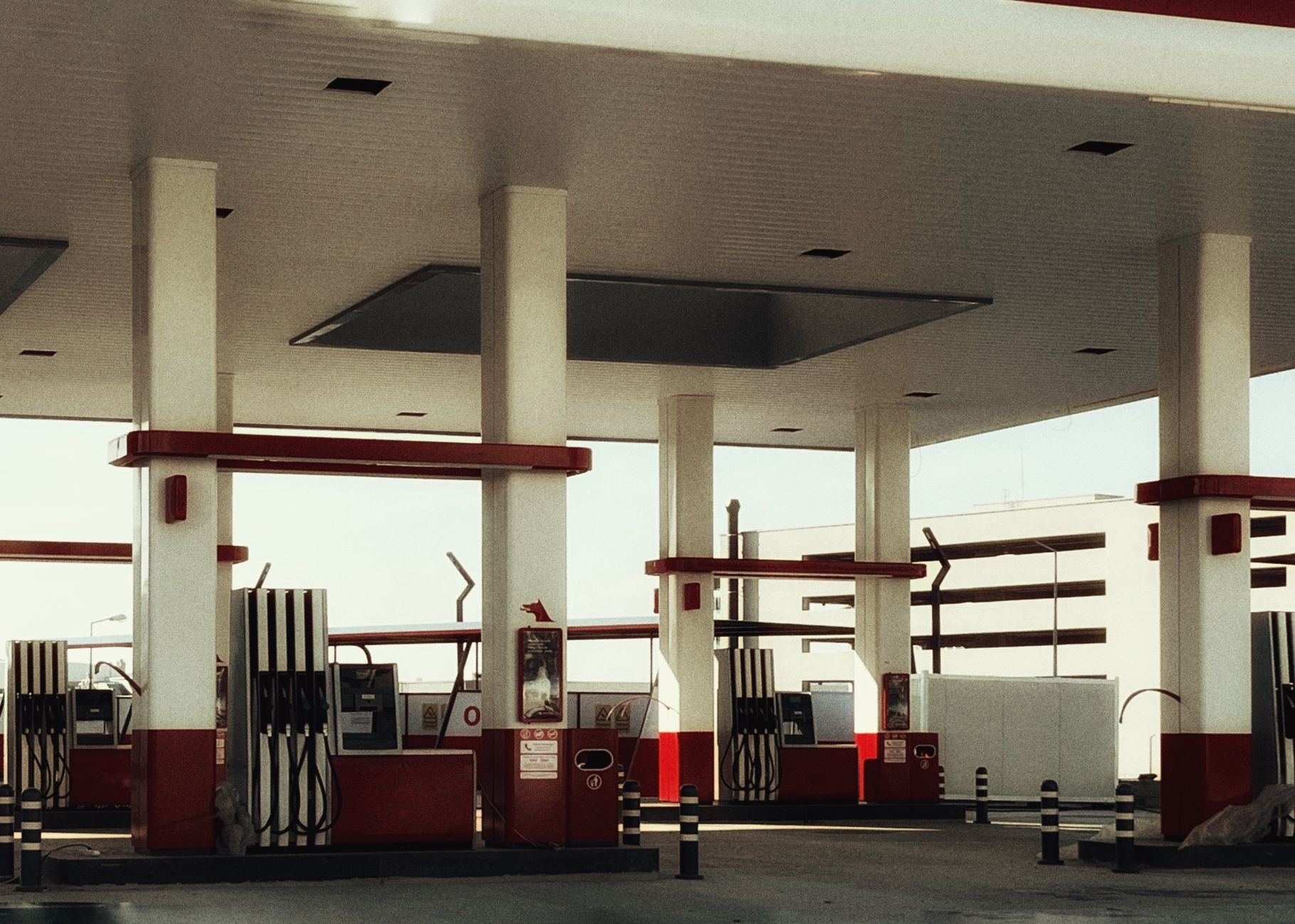 Multiple fuel pumps at a brightly lit modern gas station