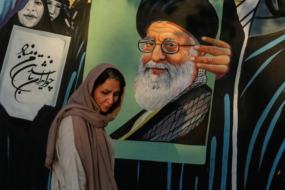 A woman walks past a mural depicting a portrait of the late Iranian Supreme Leader Ayatollah Ali Khamenei in downtown Tehran, Iran, on July 18, 2026.