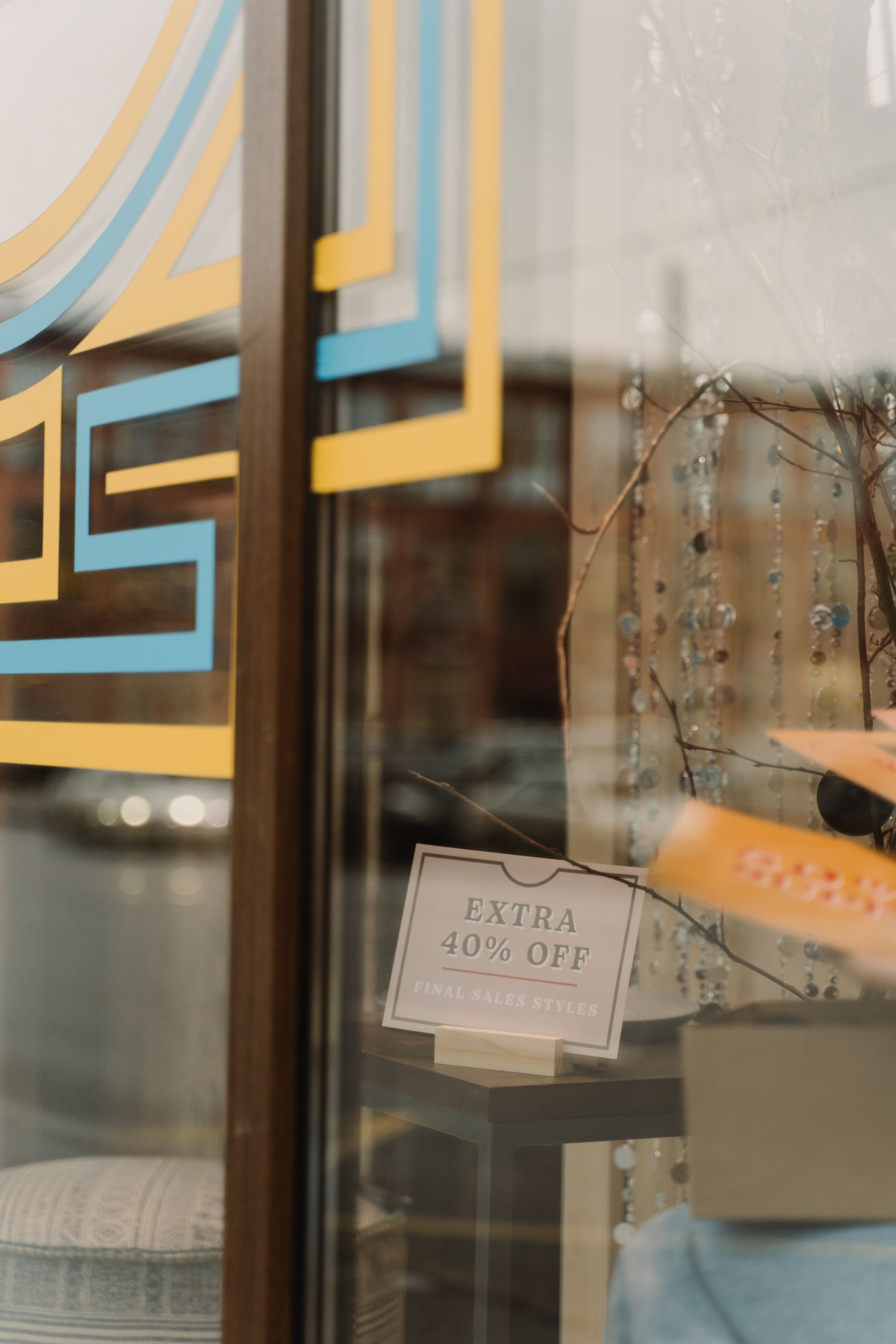 Storefront window with 40 per cent off sale signage